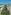 Vista aérea Miami Beach: rascacielos, palmeras, playa y océano turquesa.