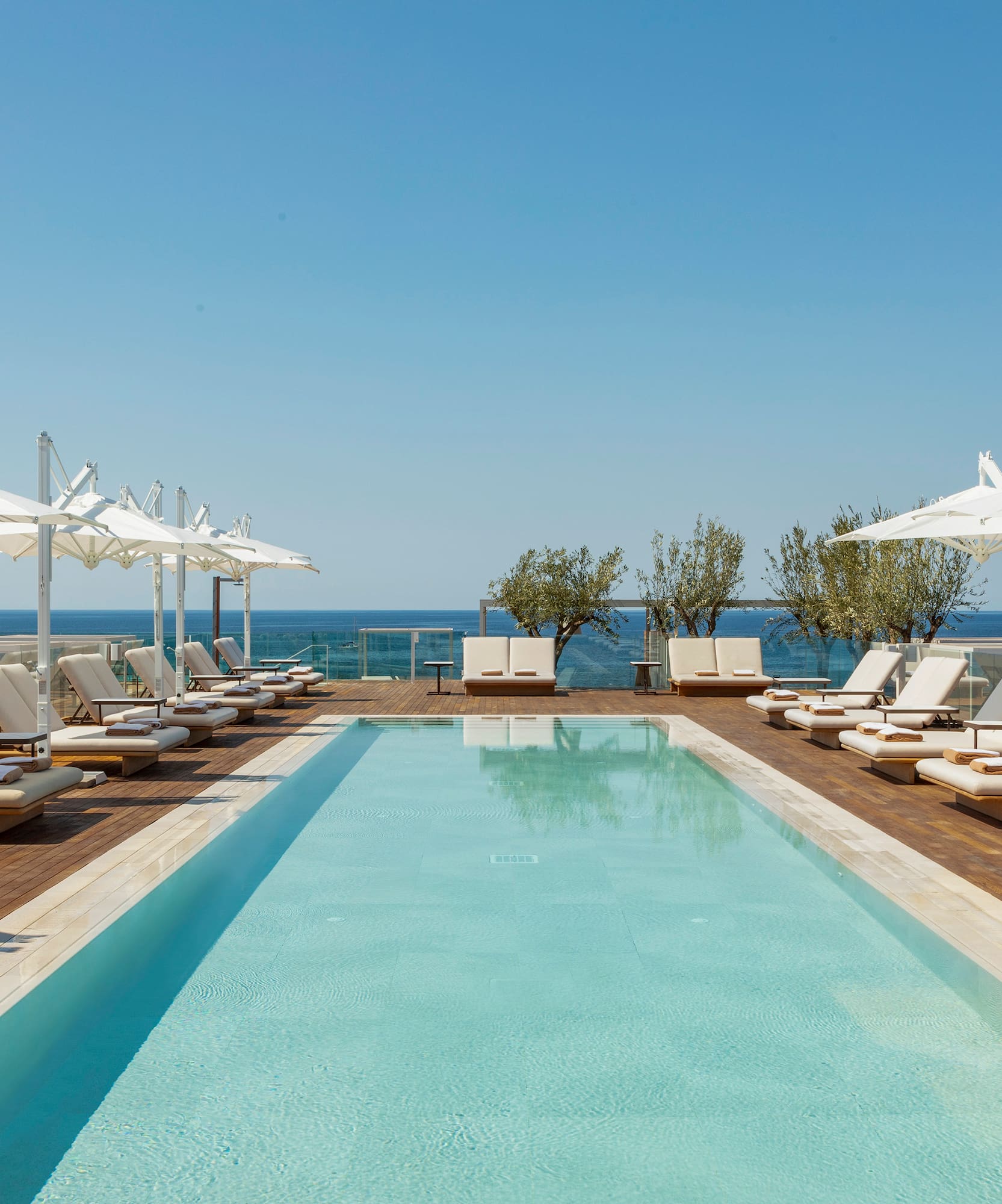a pool with lounge chairs and umbrellas
