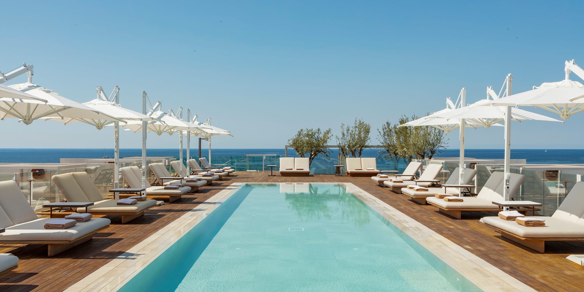 a pool with lounge chairs and umbrellas