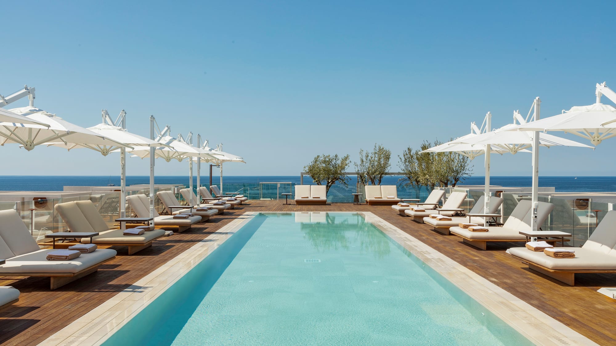 a pool with lounge chairs and umbrellas