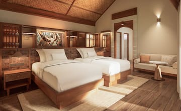 a room with two beds and a chair