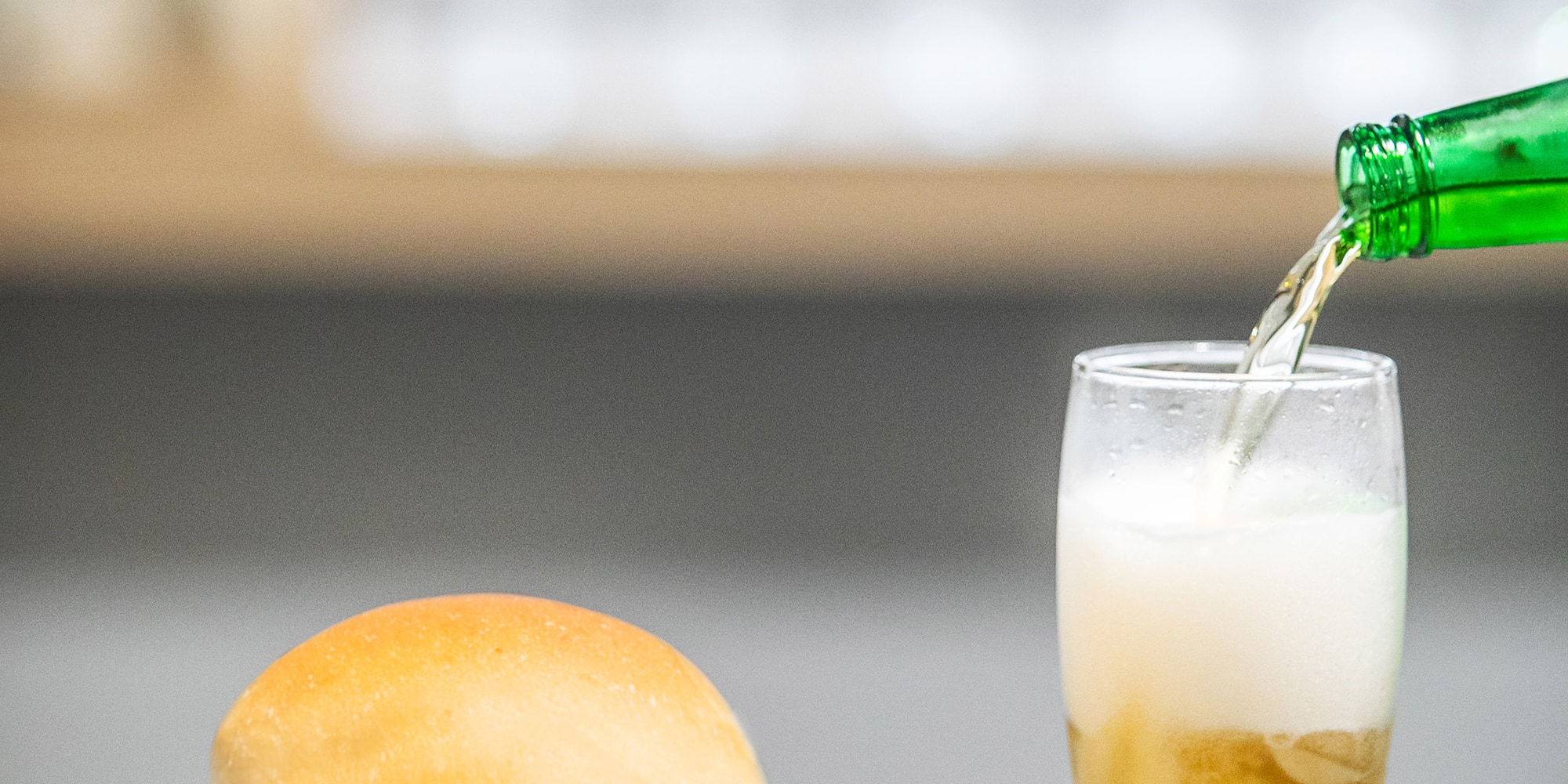 a burger and fries on a plate with a glass of beer