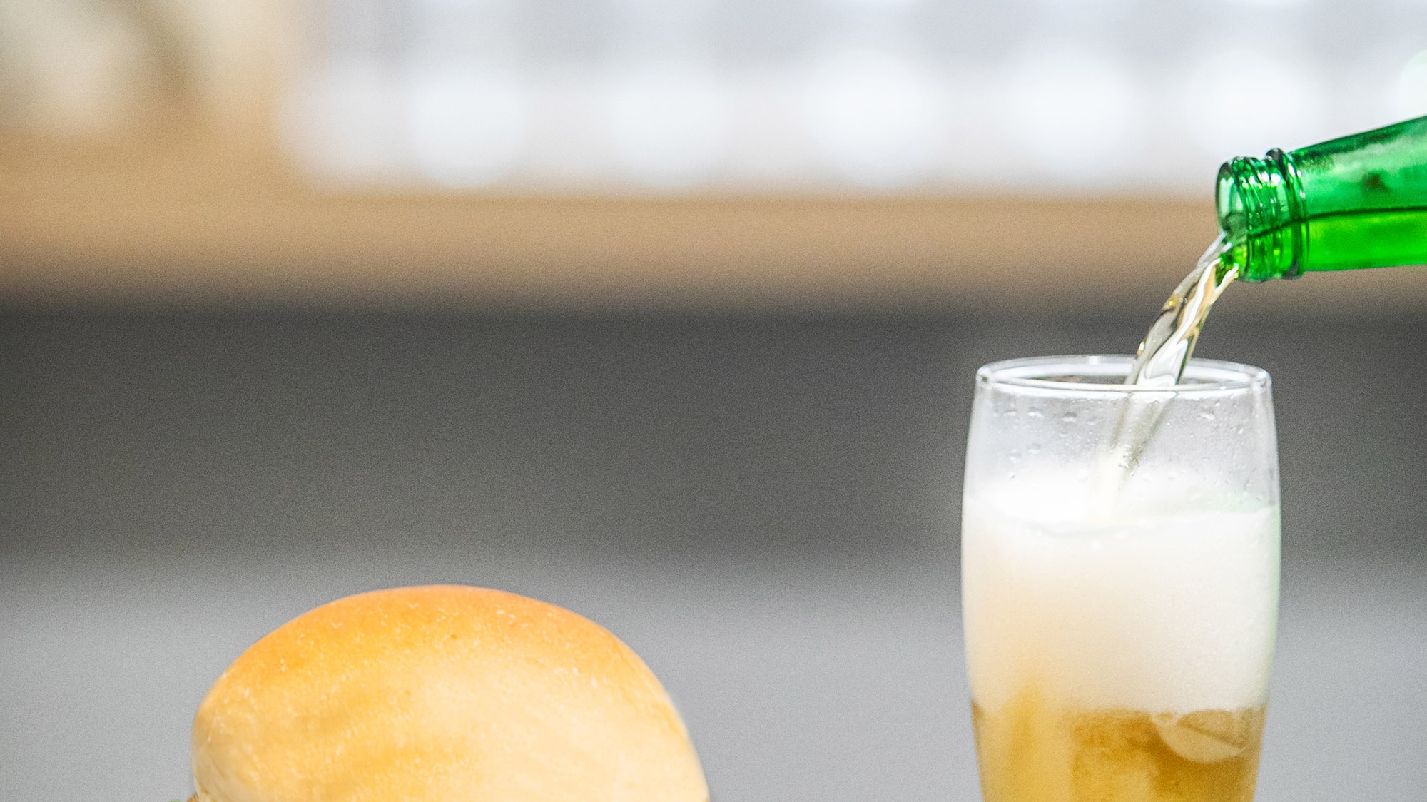 a burger and fries on a plate with a glass of beer
