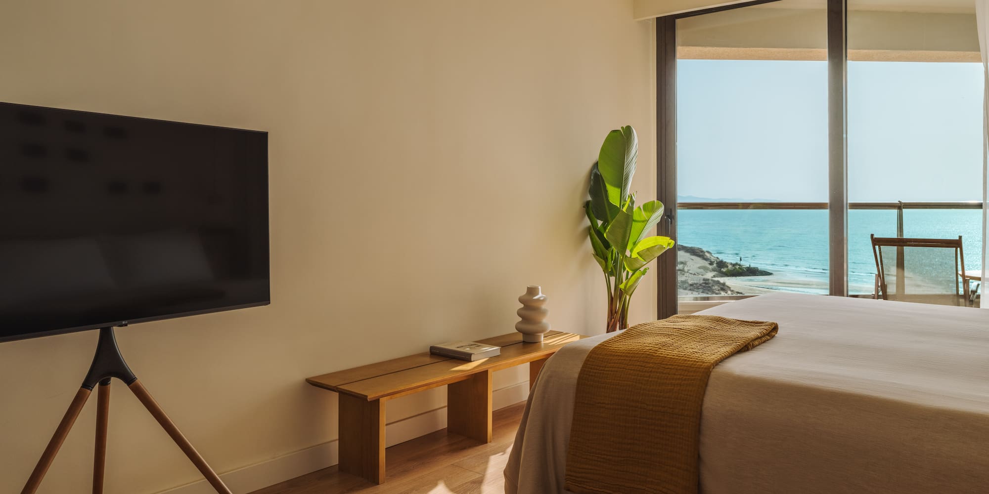 a bedroom with a television and a window