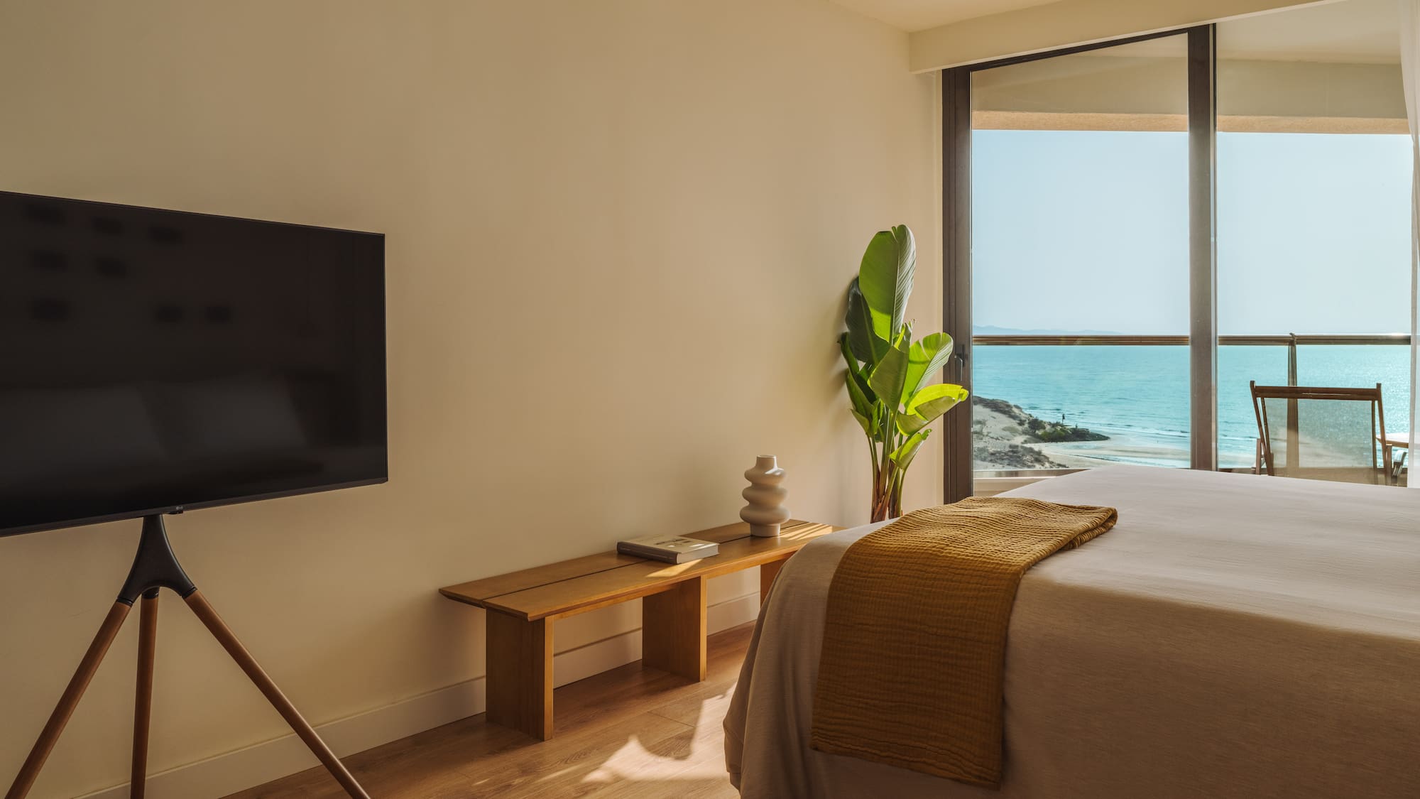 a bedroom with a television and a window