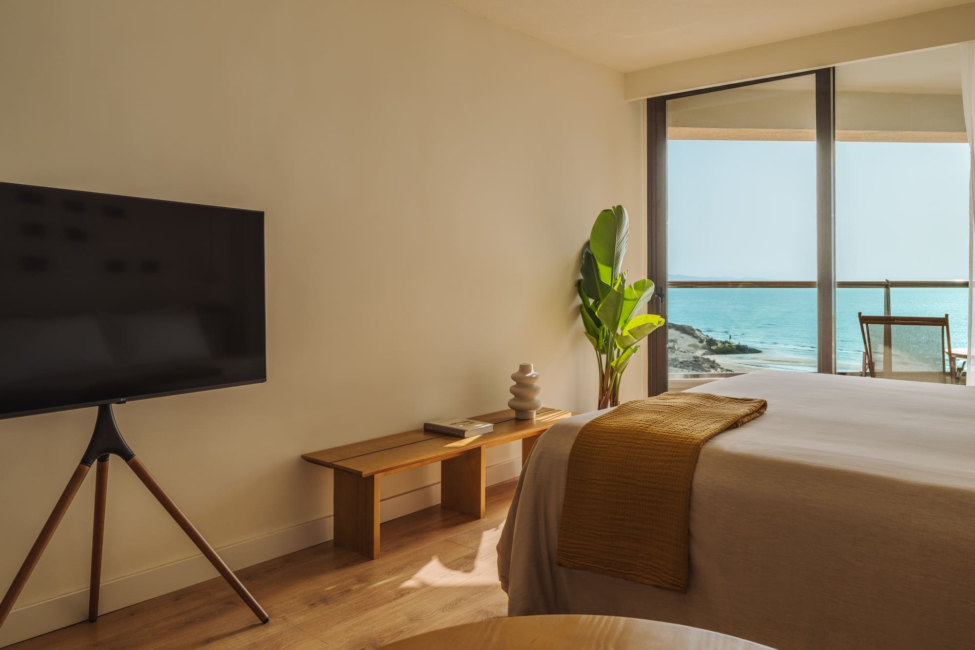 a bedroom with a television and a window