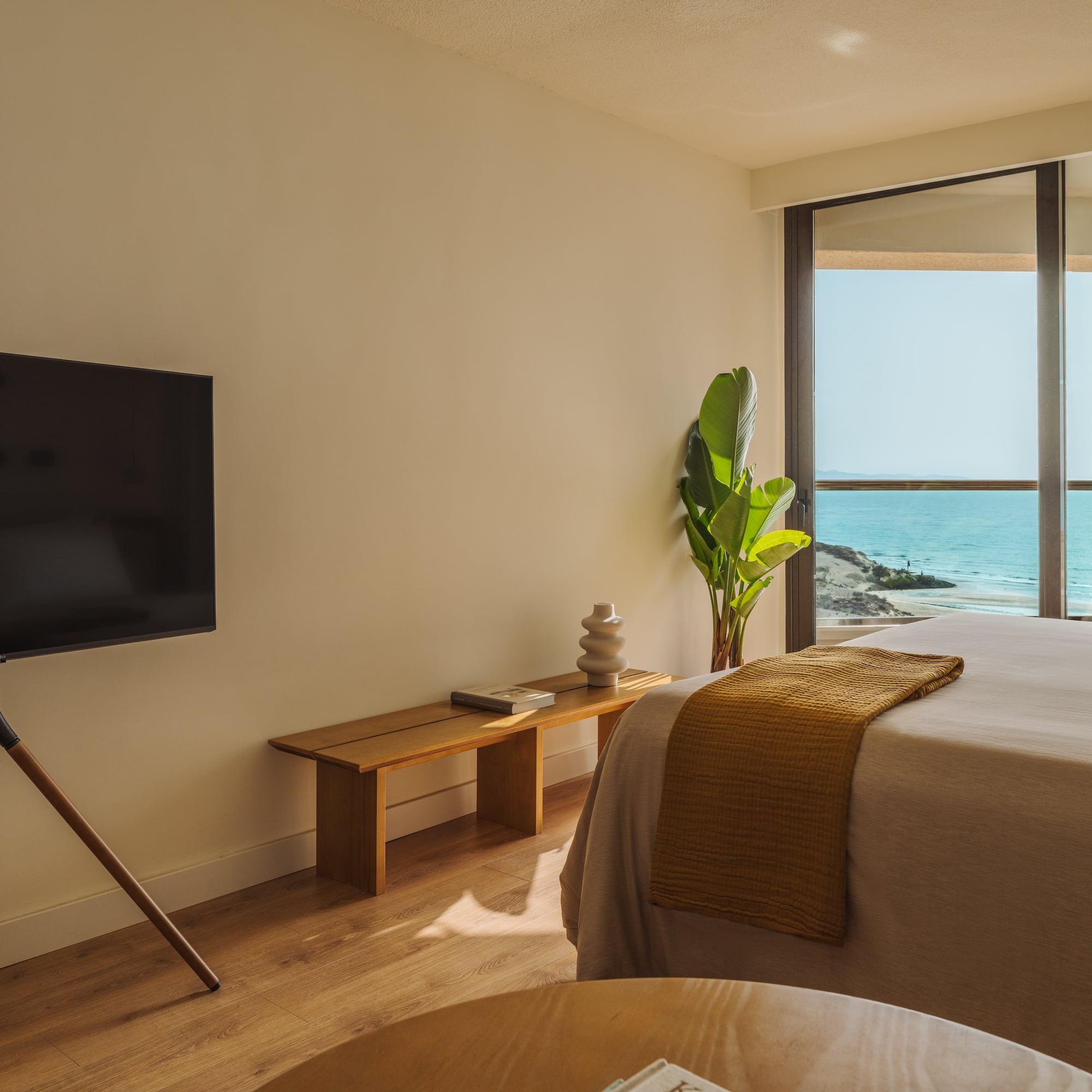 a bedroom with a television and a window