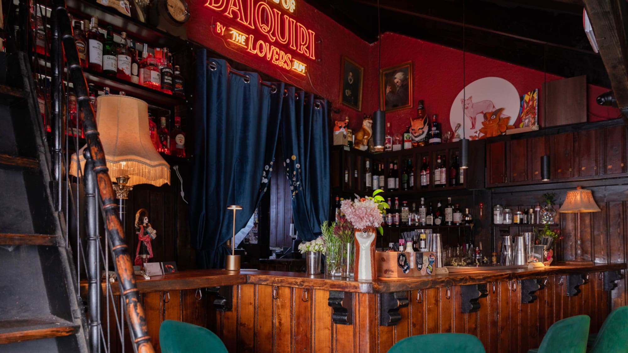 a bar with a red wall and a red sign