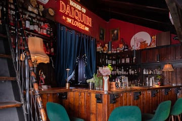 a bar with a red wall and a red sign