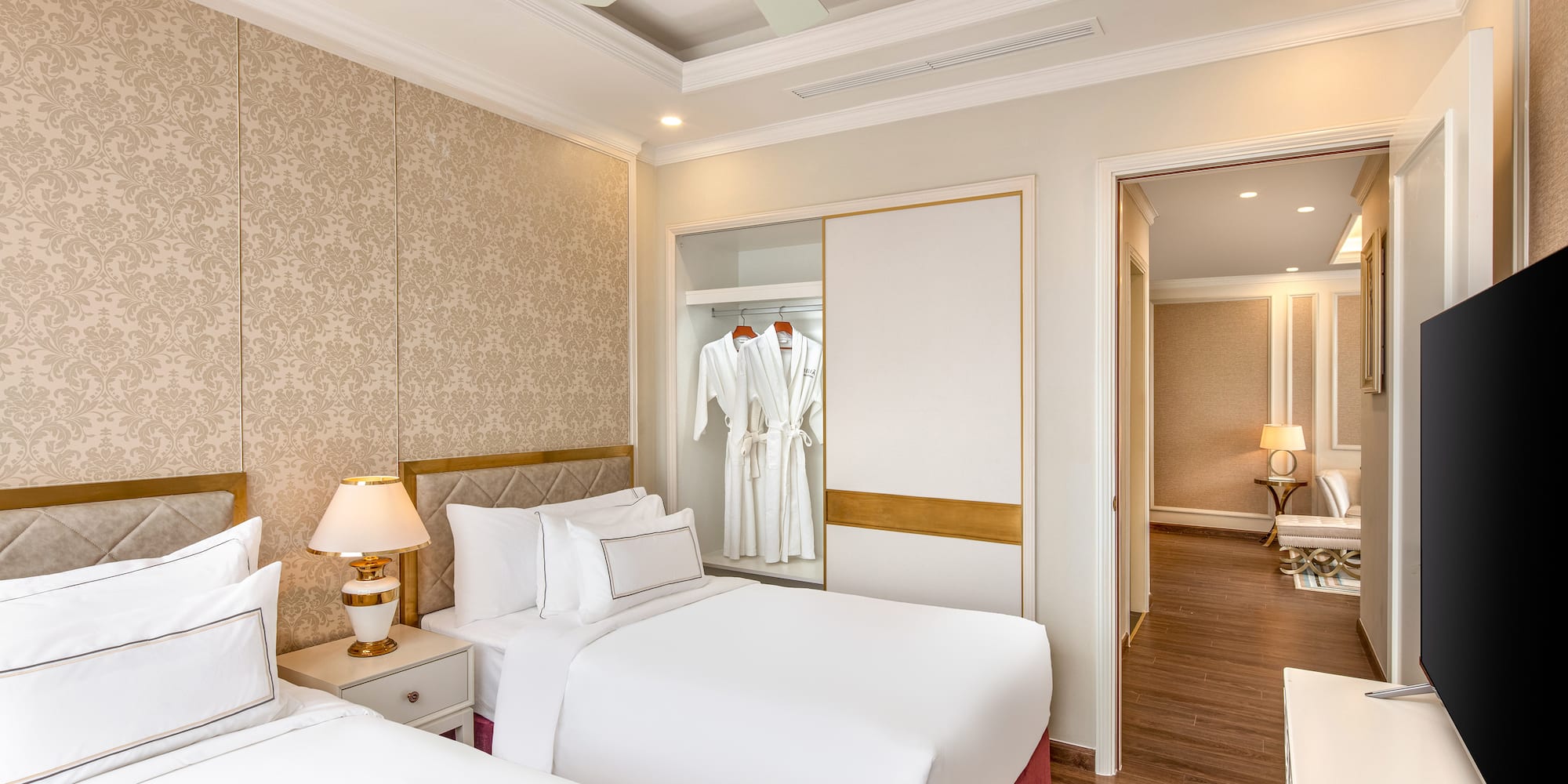 a room with two beds and a ceiling fan