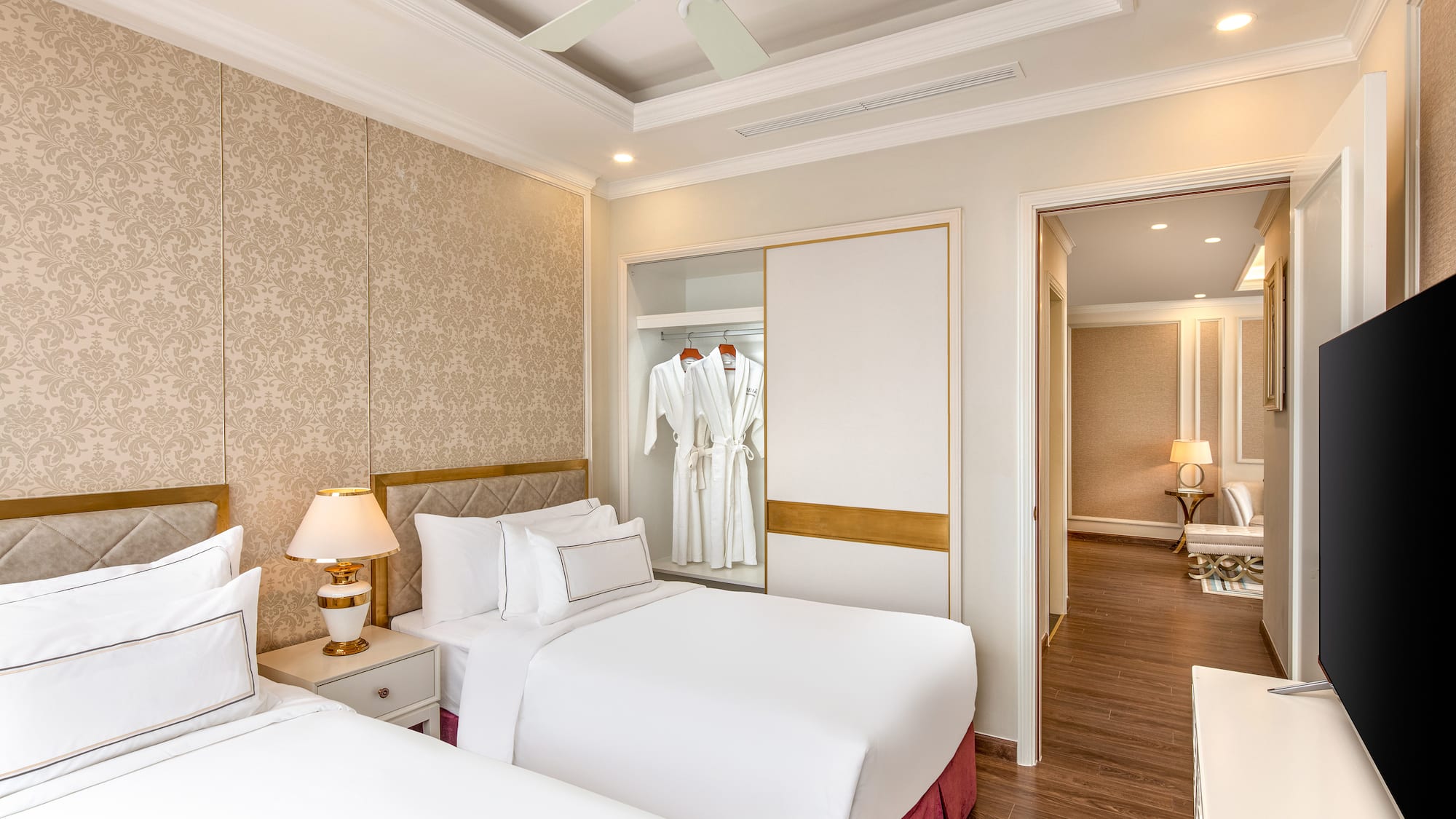 a room with two beds and a ceiling fan