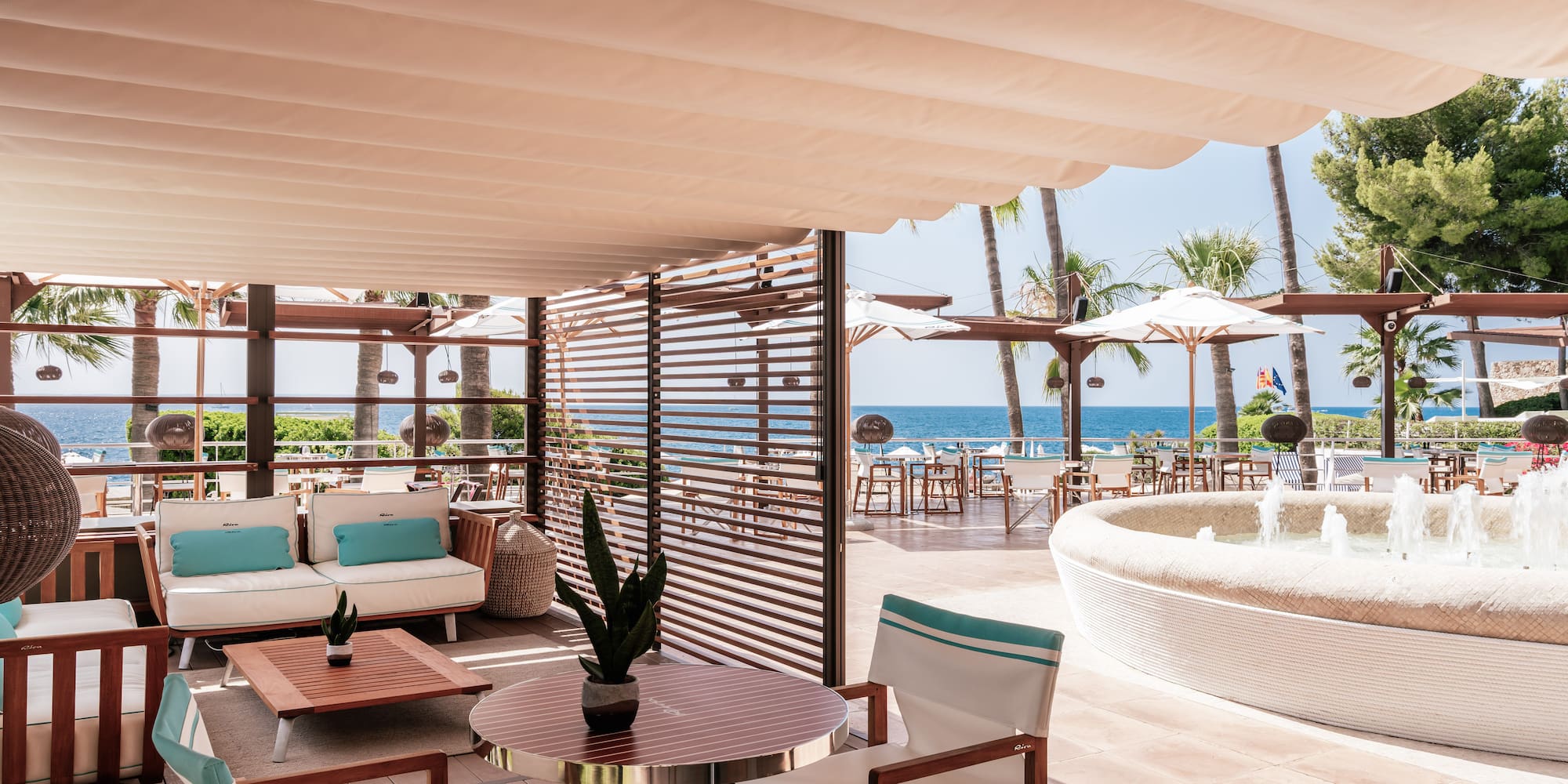 a patio with a hot tub and a table and chairs