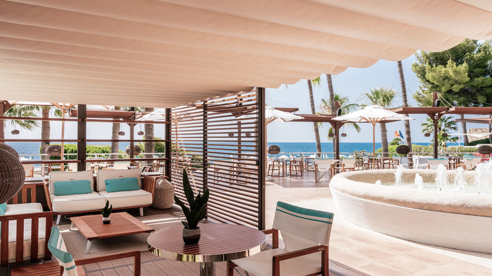 a patio with a hot tub and a table and chairs