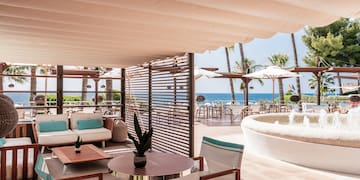 a patio with a hot tub and a table and chairs