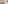 Beachfront dining terrace with shaded canopy, ocean view, palm trees, and fountain.