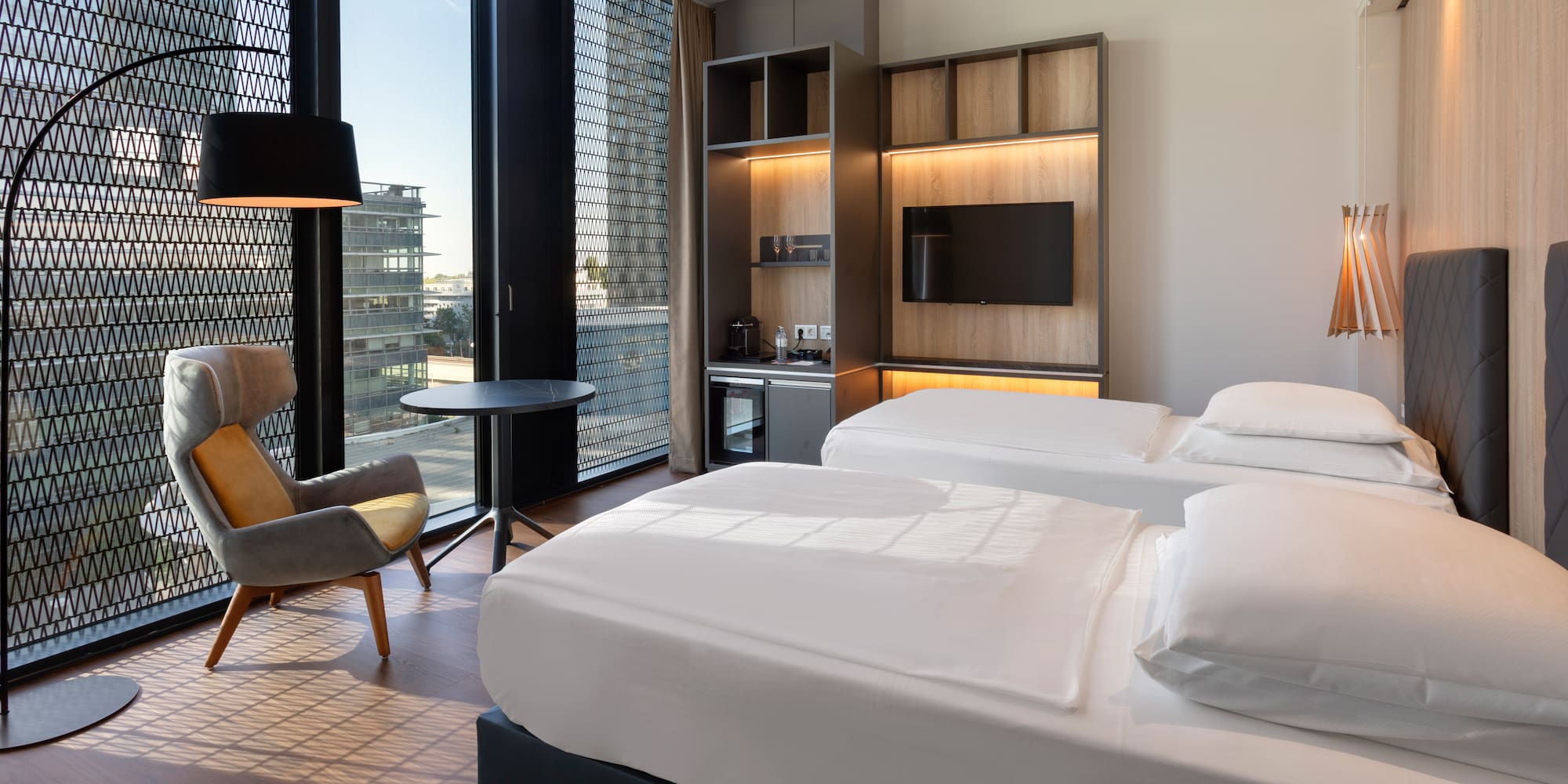 a room with two beds and a chair