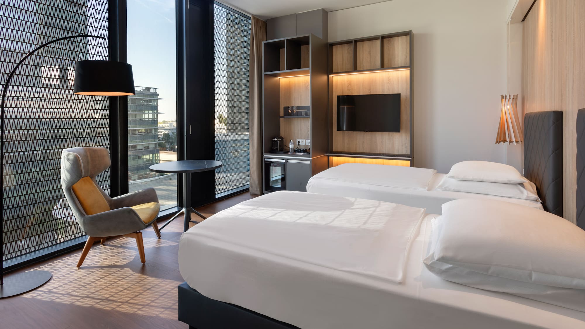 a room with two beds and a chair