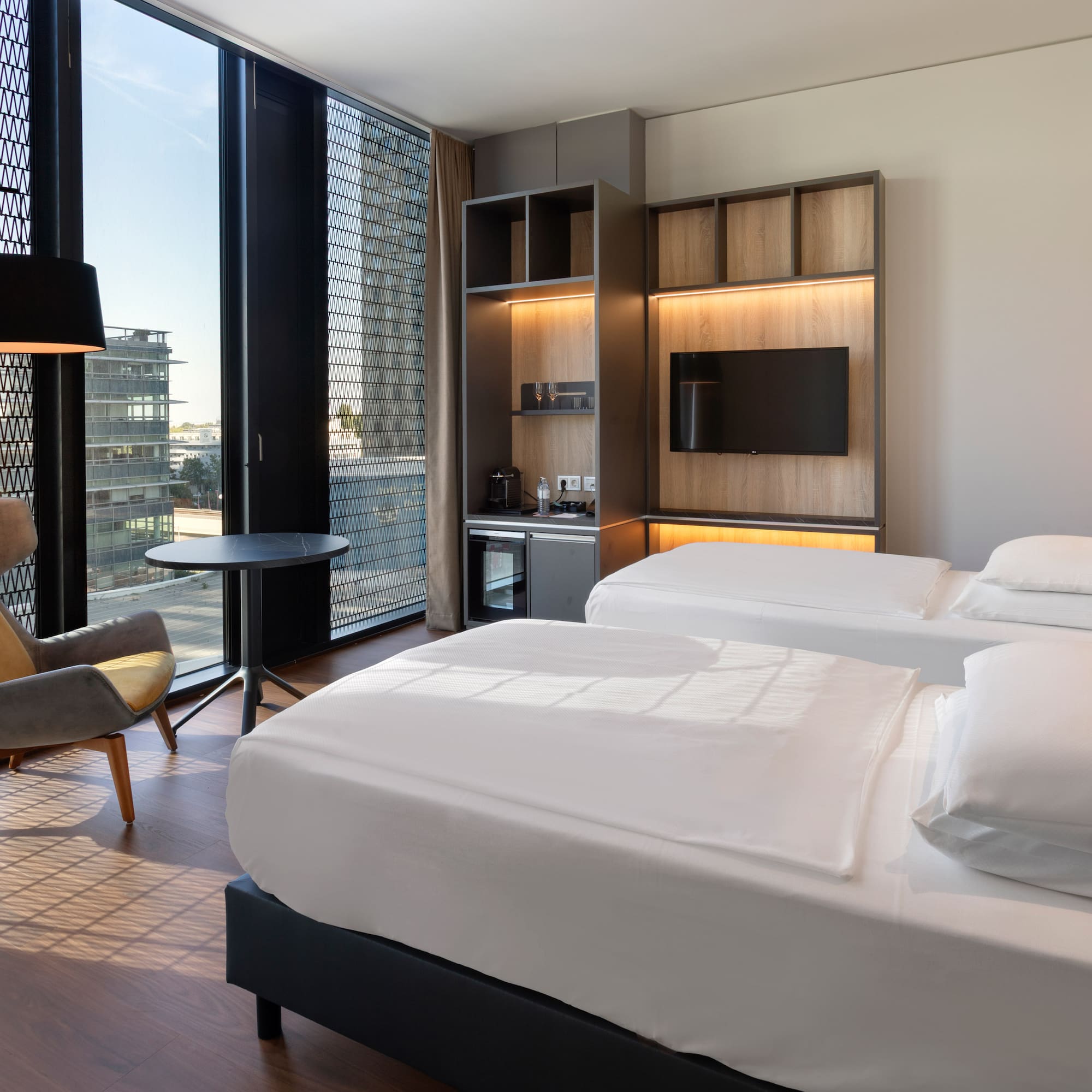 a room with two beds and a chair