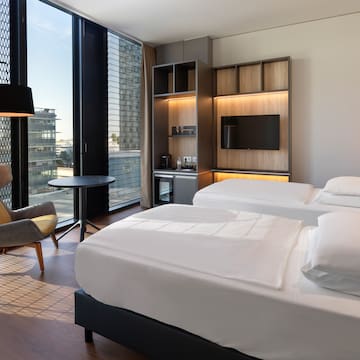 a room with two beds and a chair