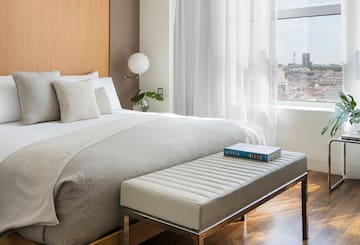 a bed with a bench in a room