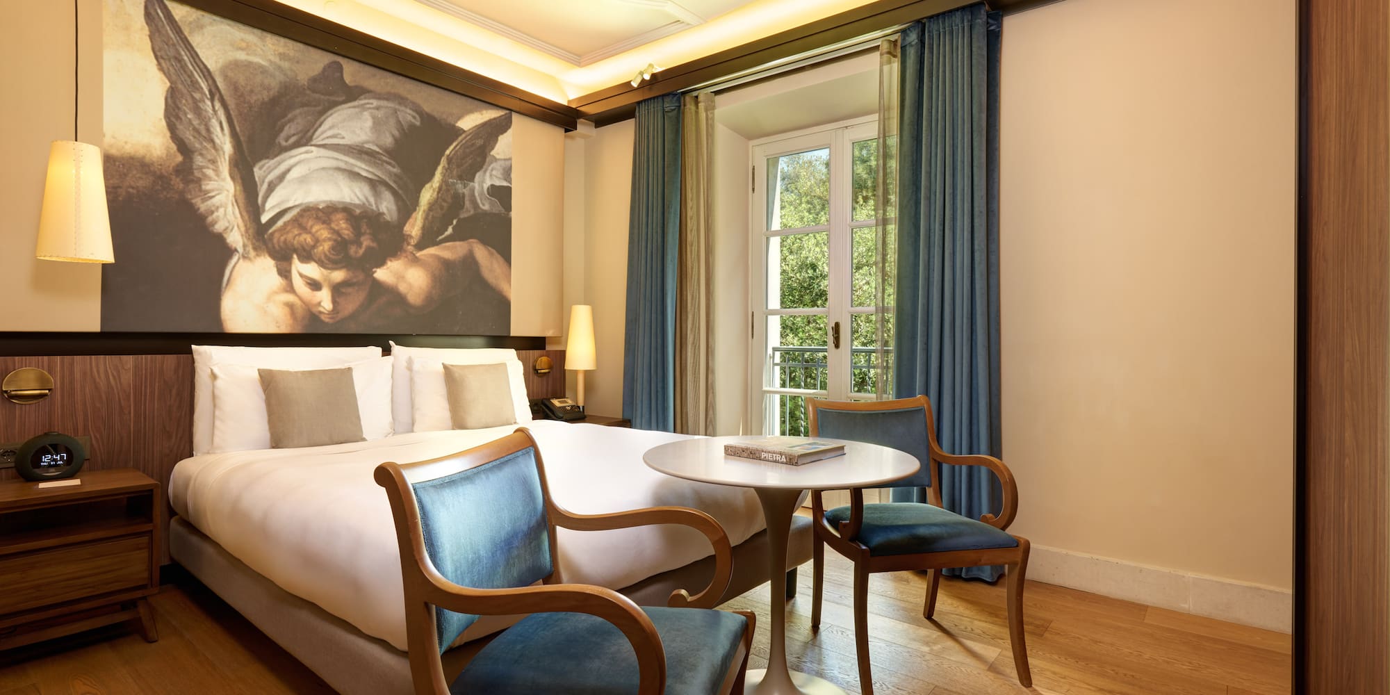 a room with a bed and chairs