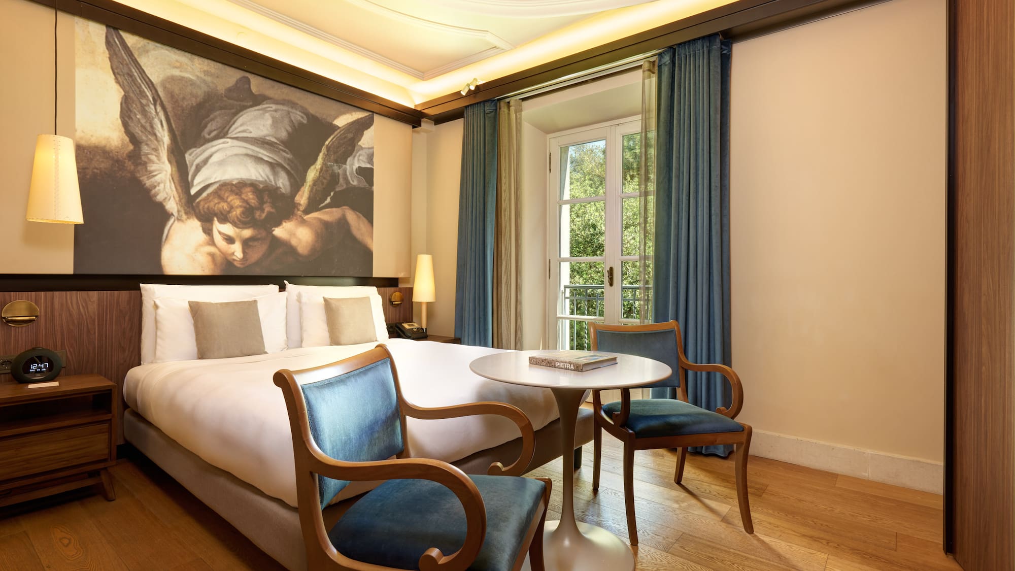 a room with a bed and chairs