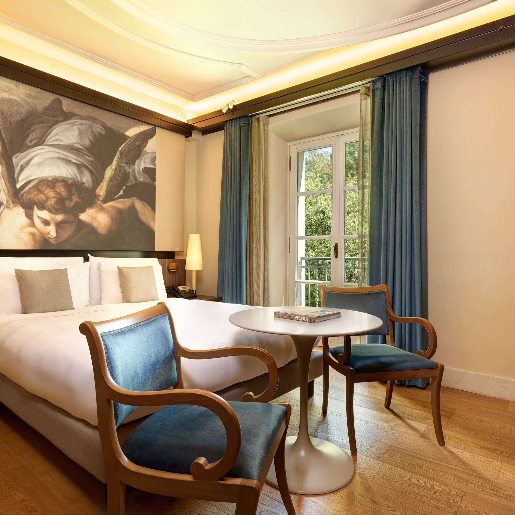 a room with a bed and chairs