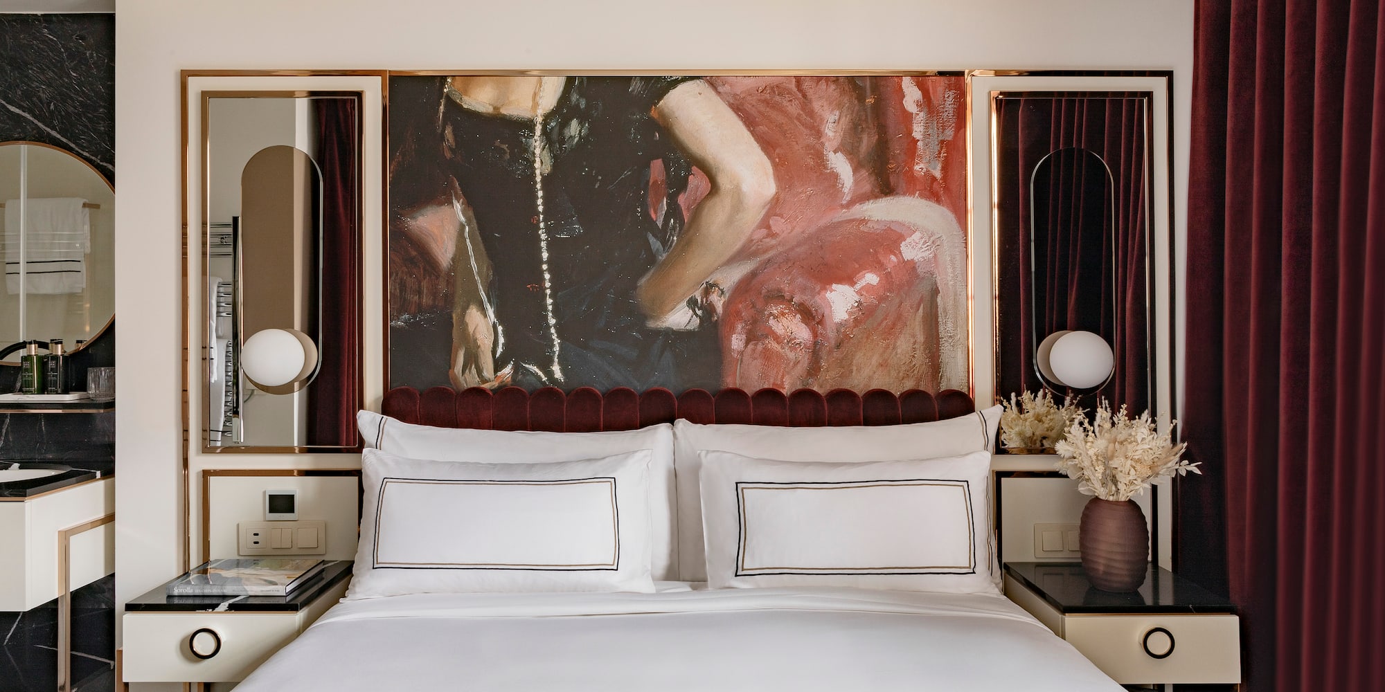 a bed with a painting above it