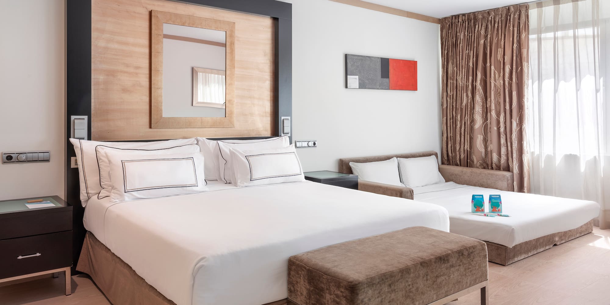 a room with two beds and a mirror