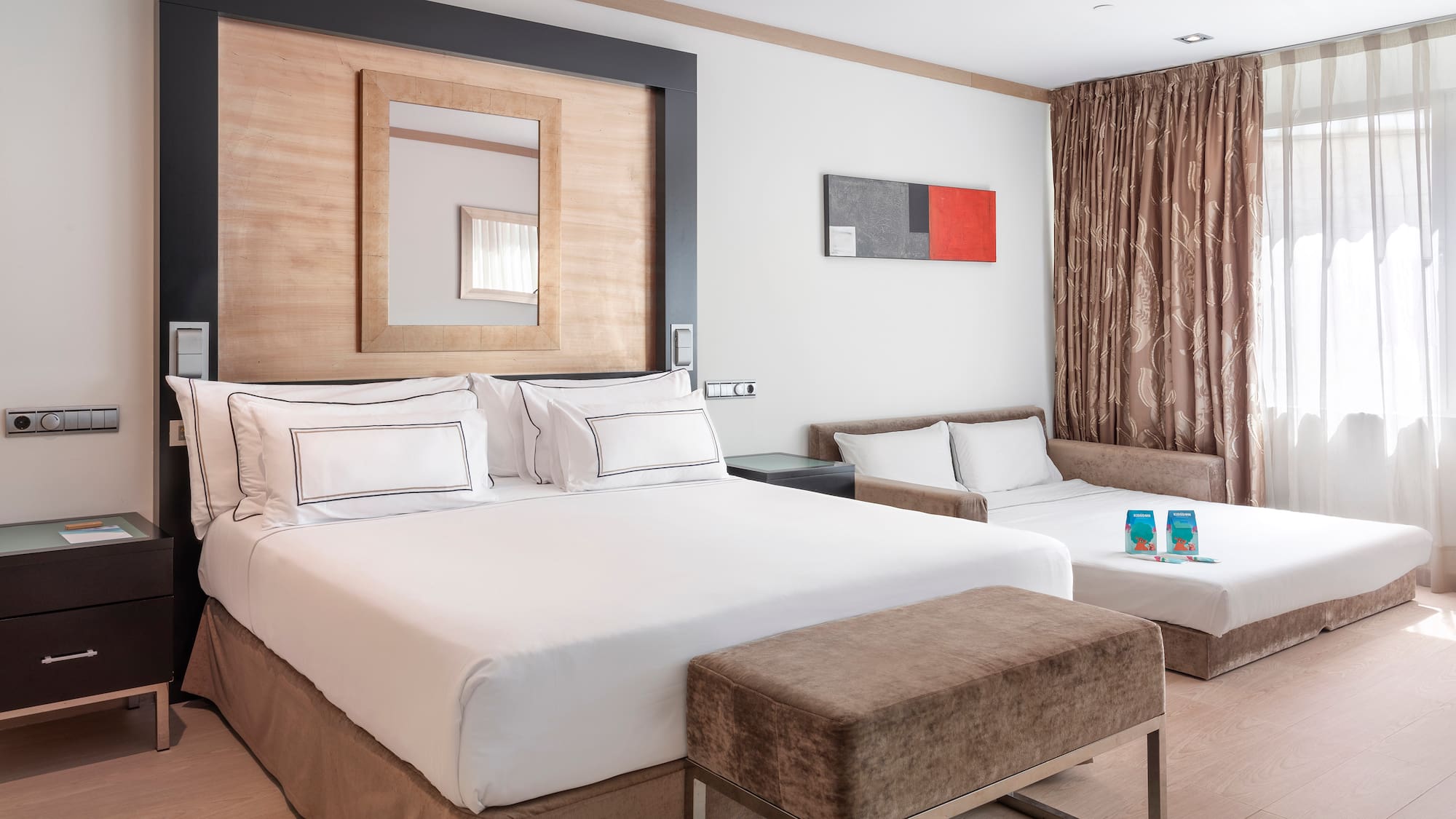 a room with two beds and a mirror