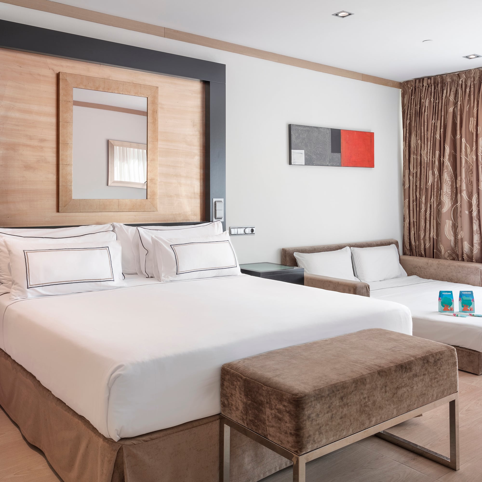 a room with two beds and a mirror