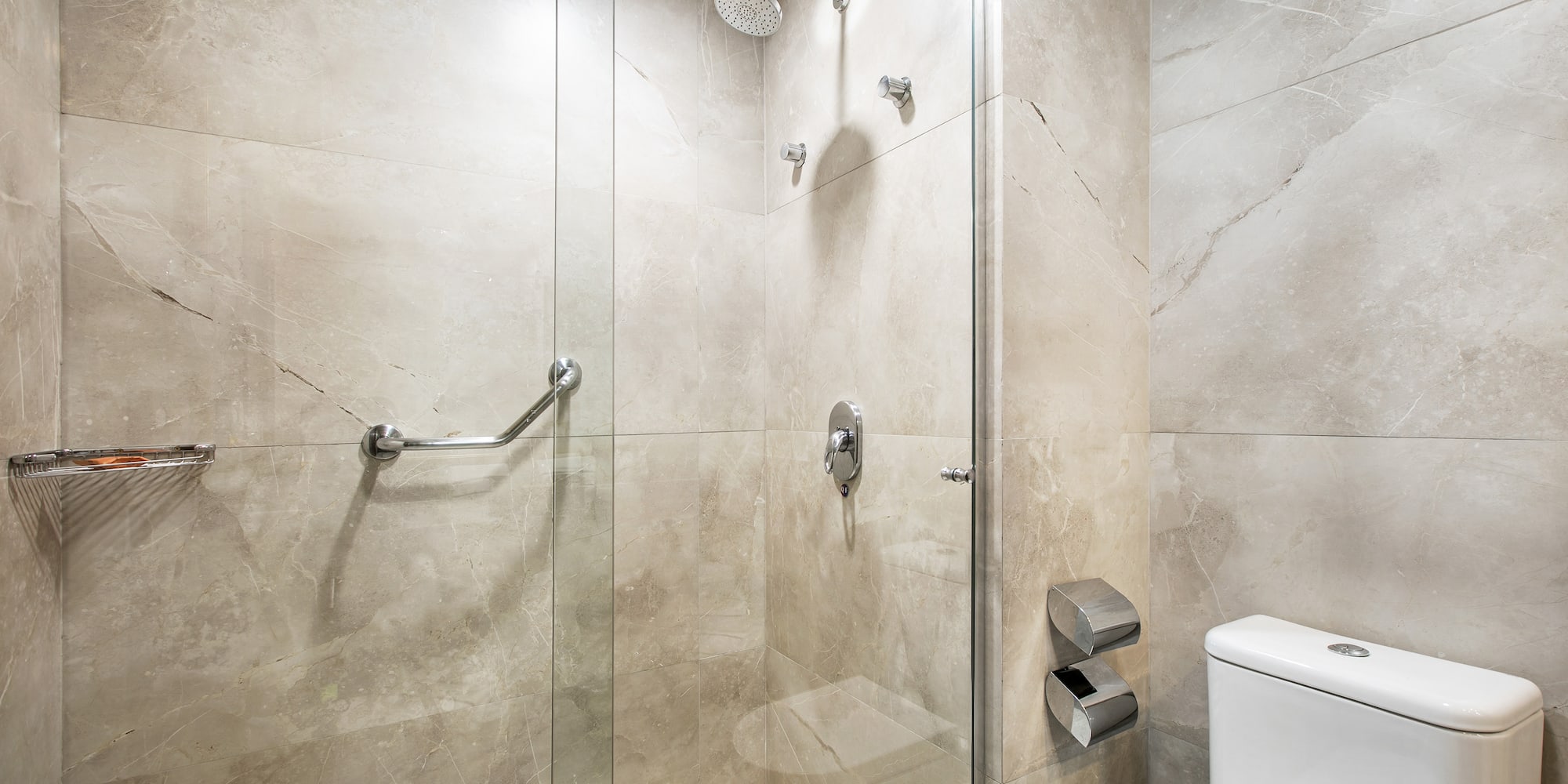 a bathroom with a glass shower and toilet