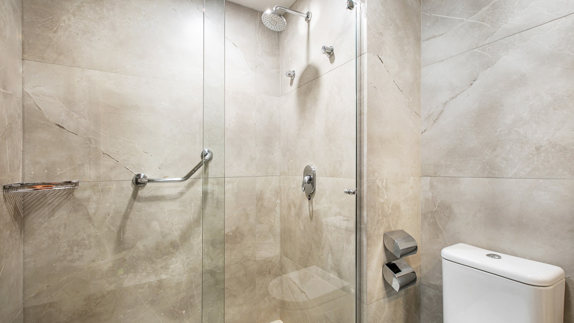 a bathroom with a glass shower and toilet