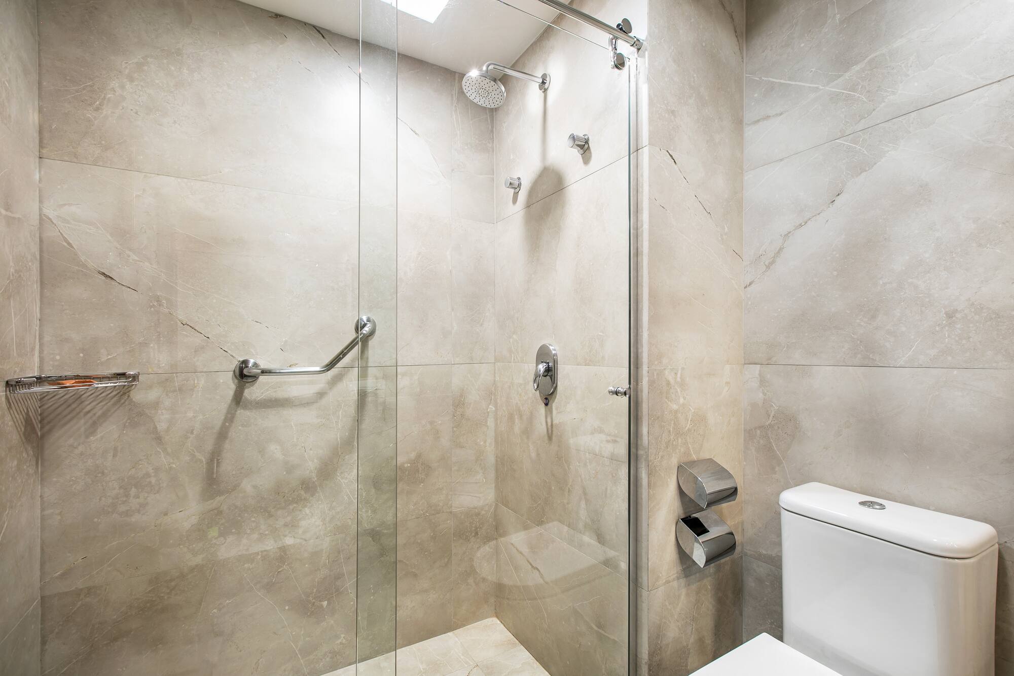 a bathroom with a glass shower and toilet