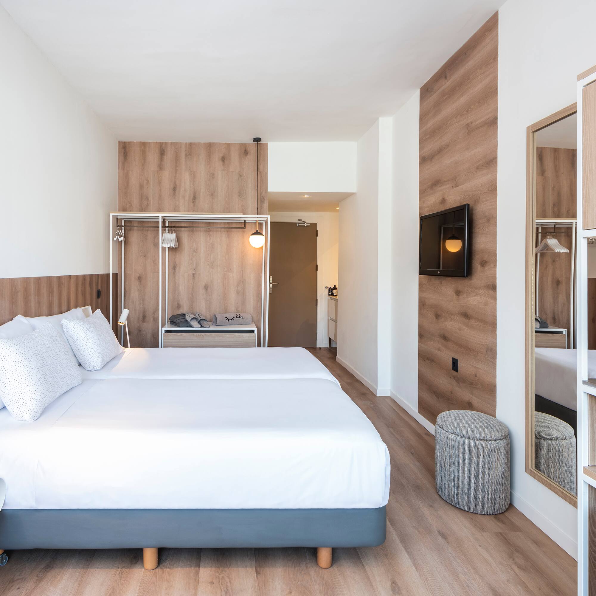 a room with a bed and a mirror