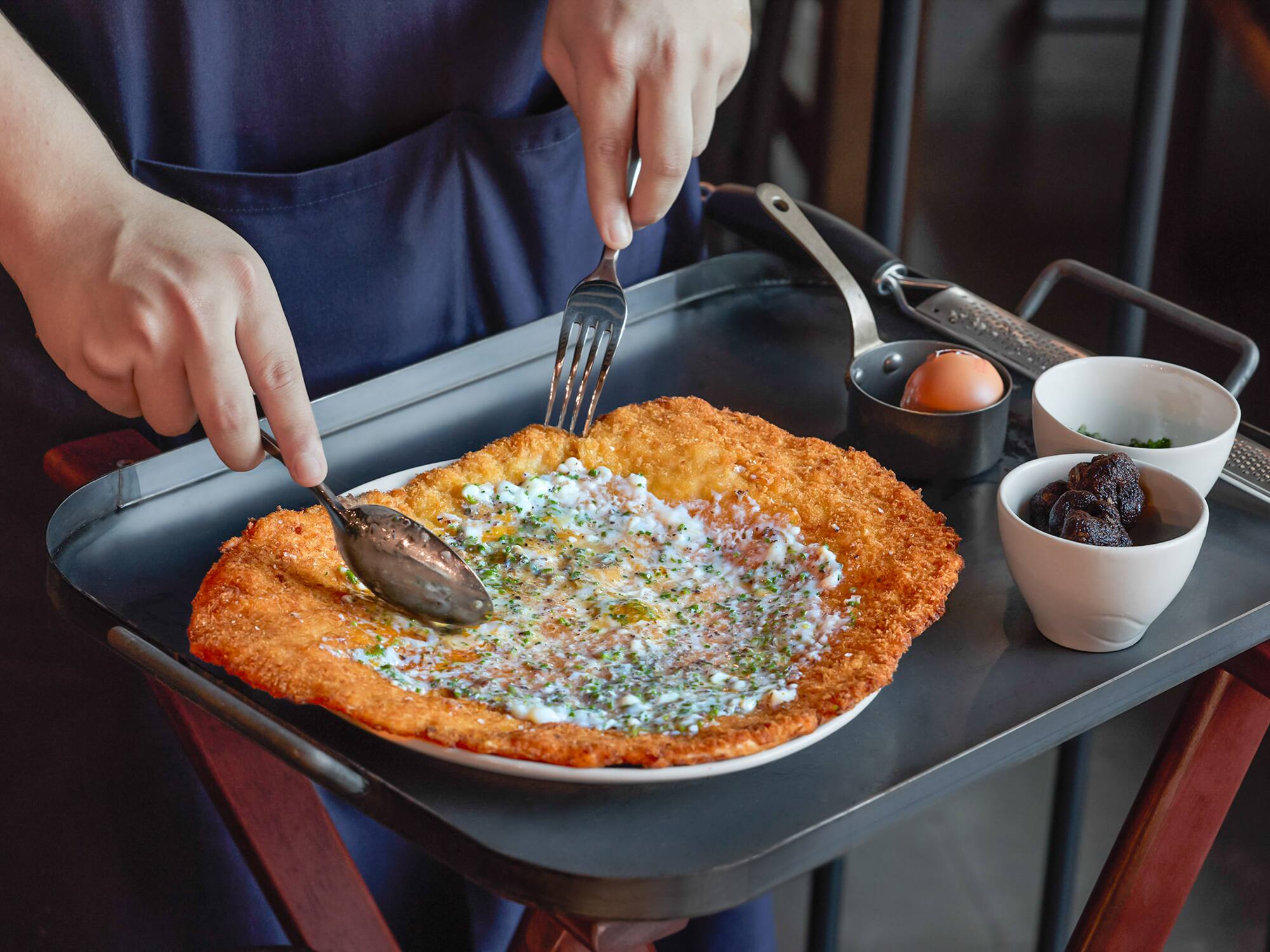a person eating food on a tray