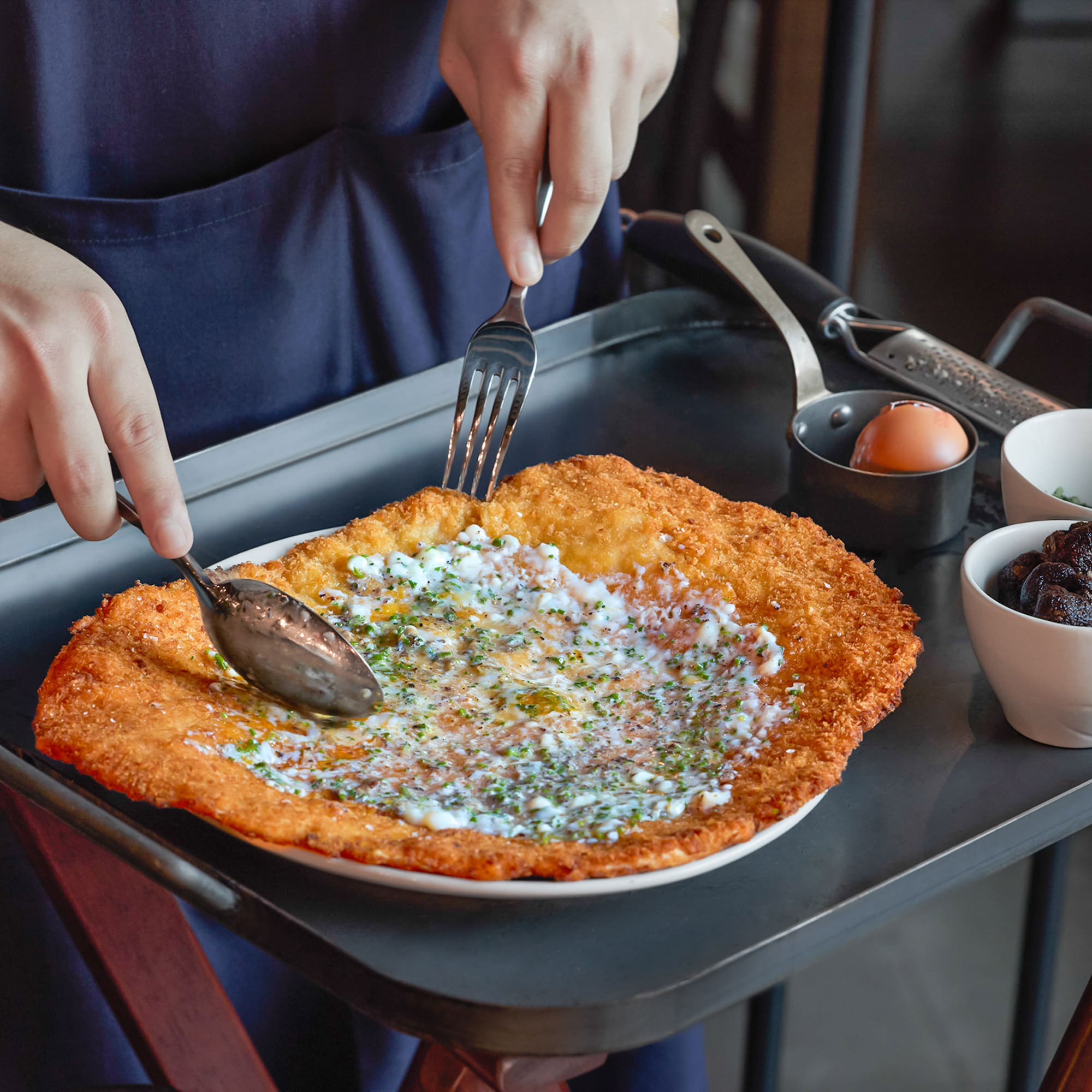 a person eating food on a tray