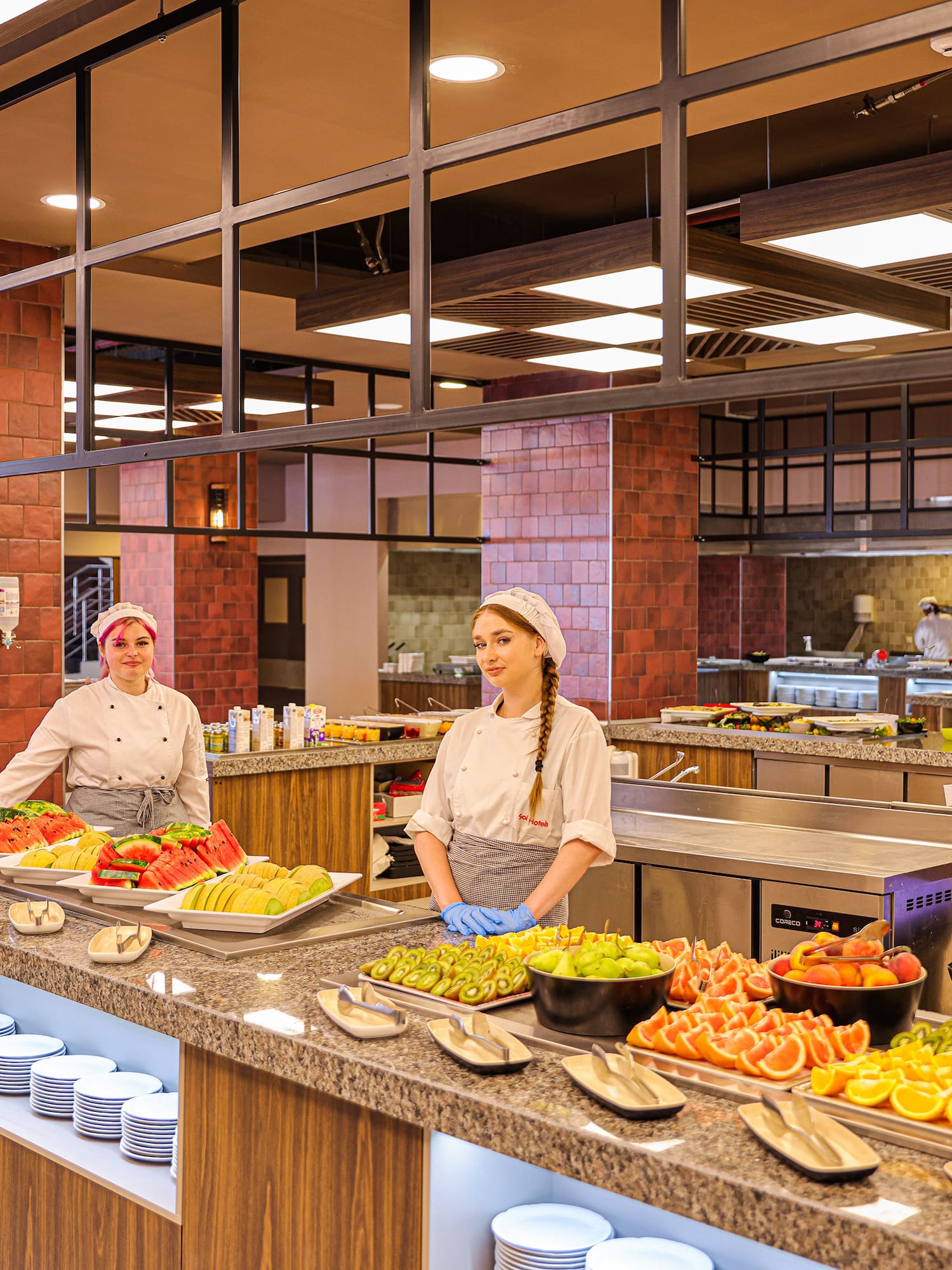 two women in a kitchen with food on the counter
