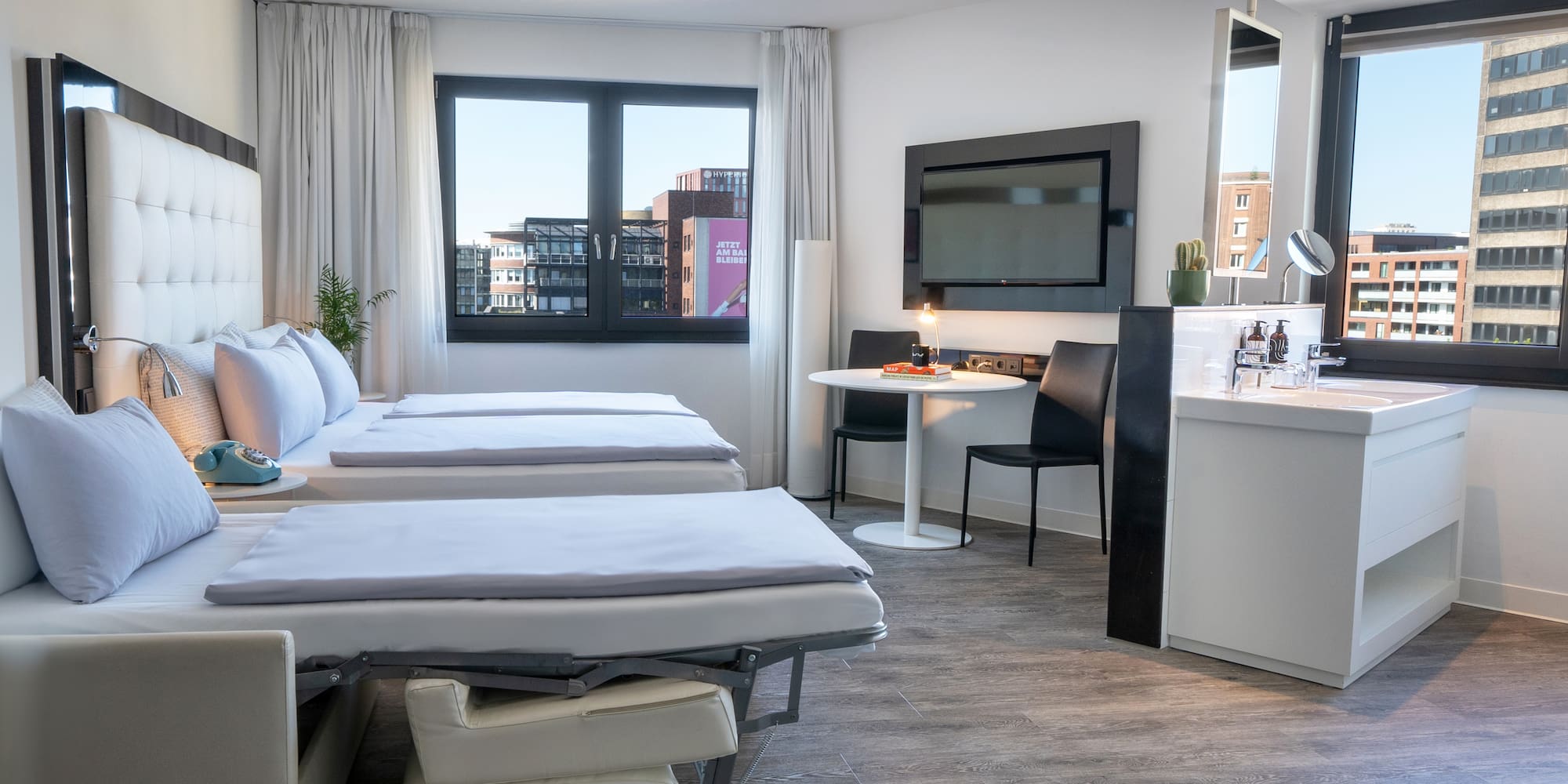 a room with two beds and a tv