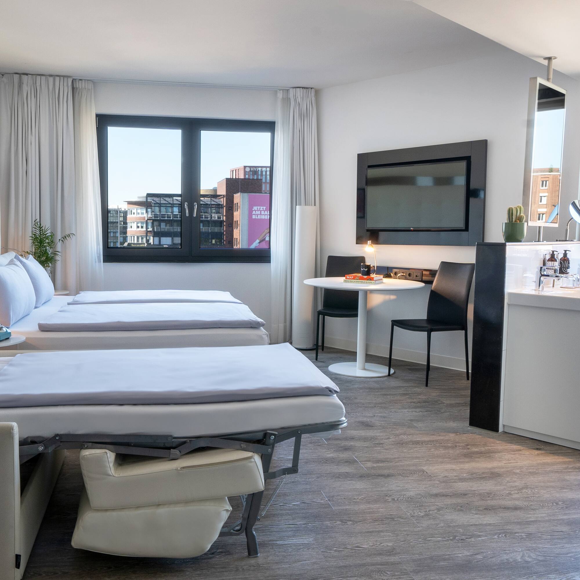 a room with two beds and a tv