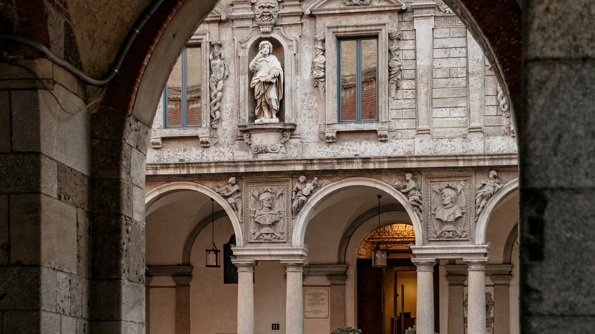 a stone building with columns and a statue