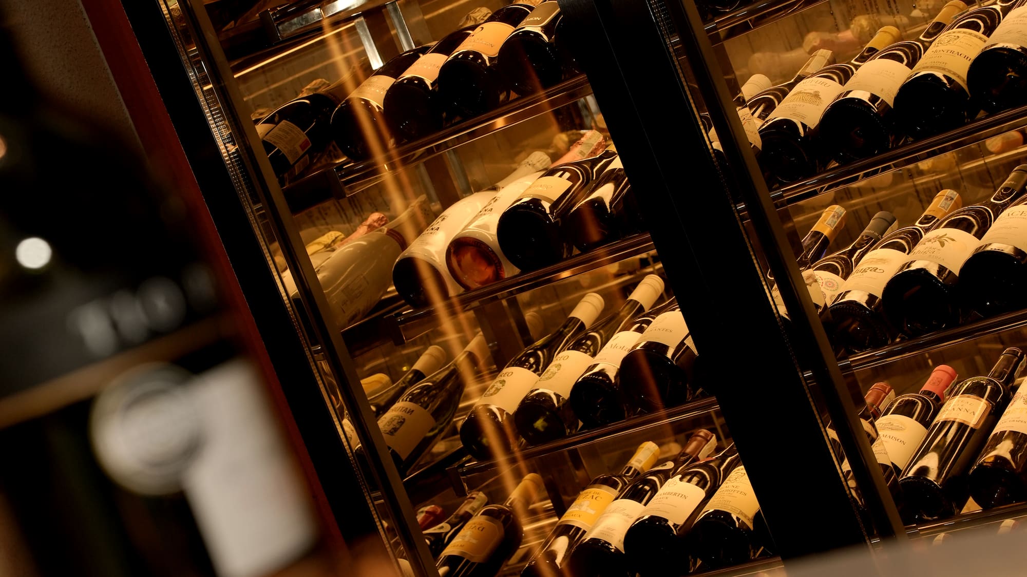 a wine cooler with bottles of wine