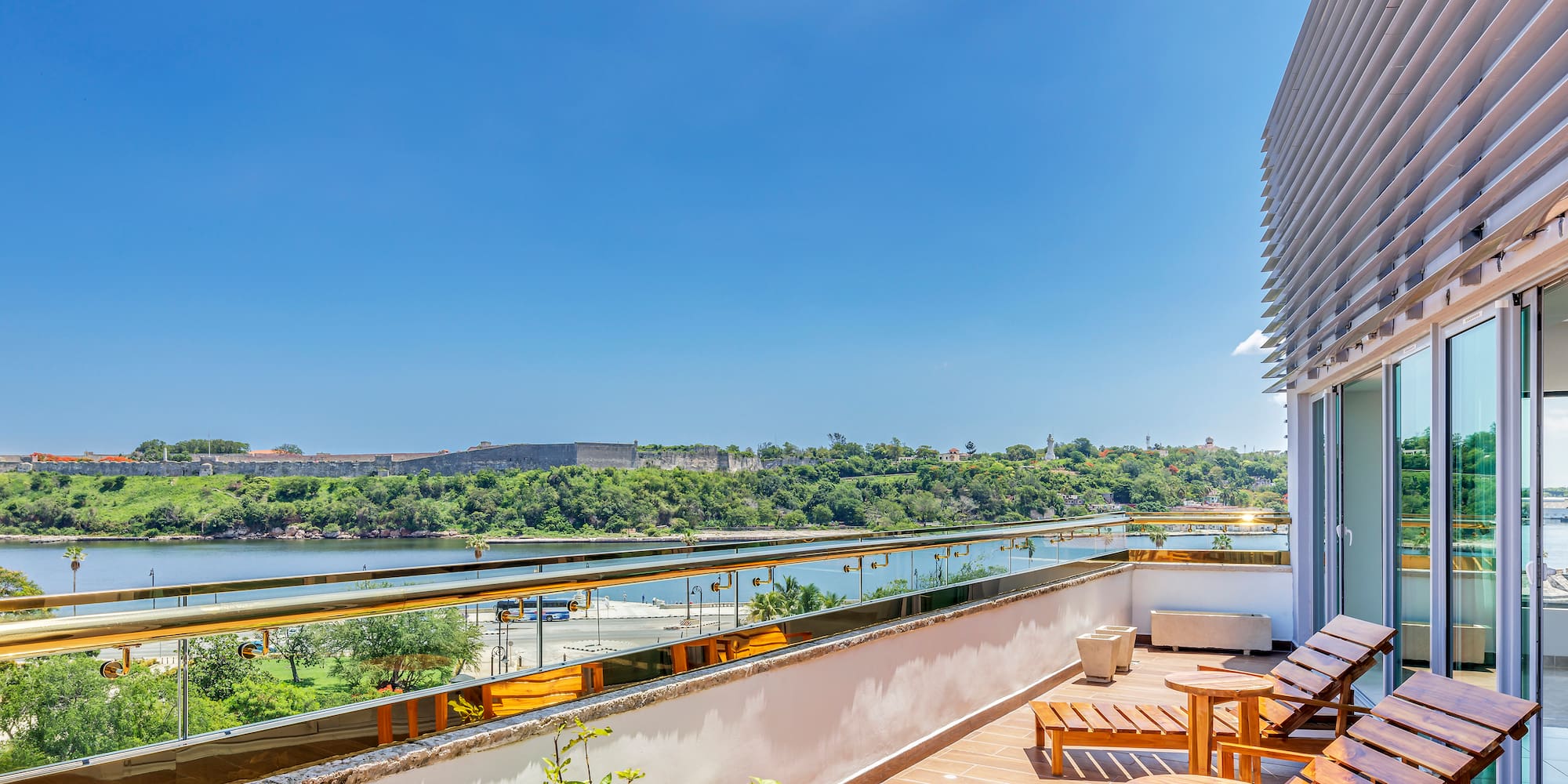 a deck with chairs and a view of a river