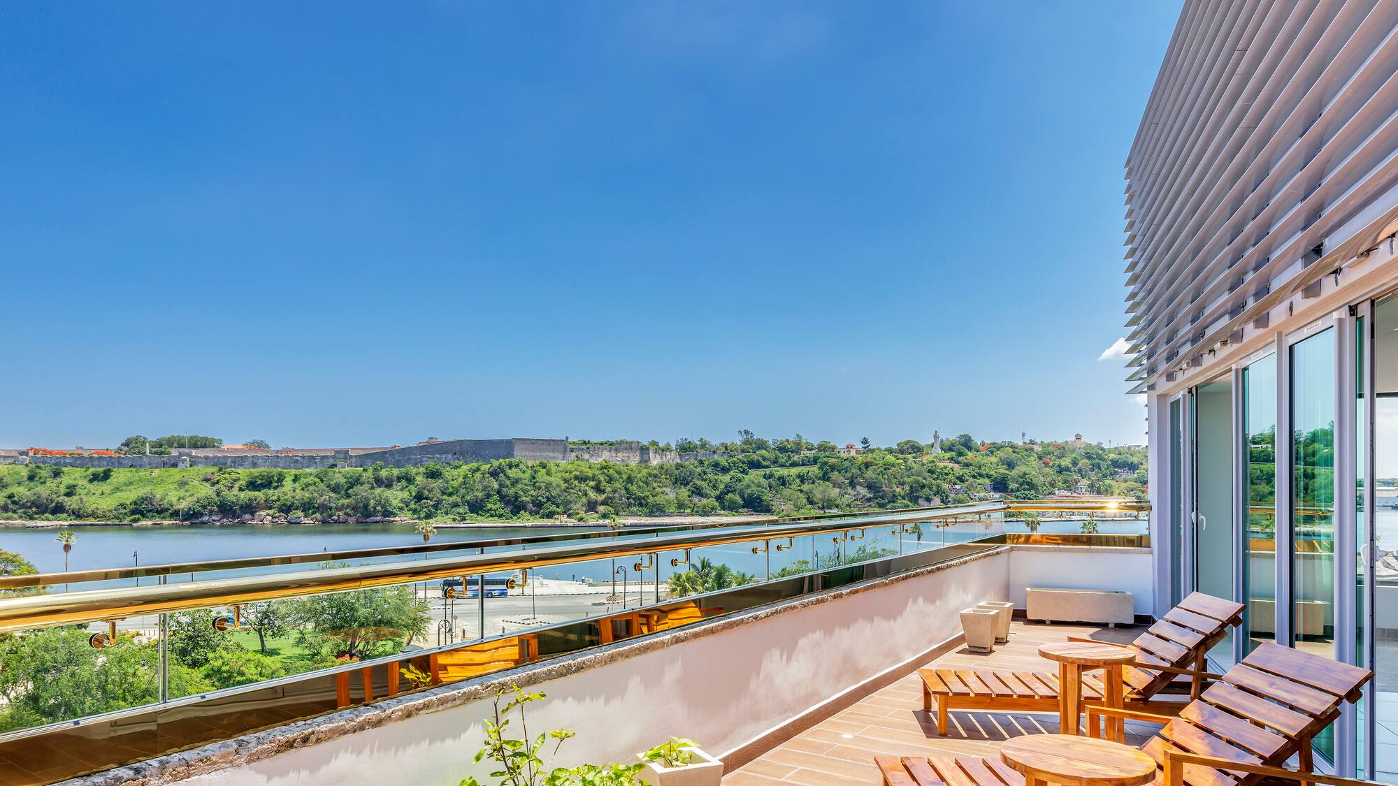 a deck with chairs and a view of a river