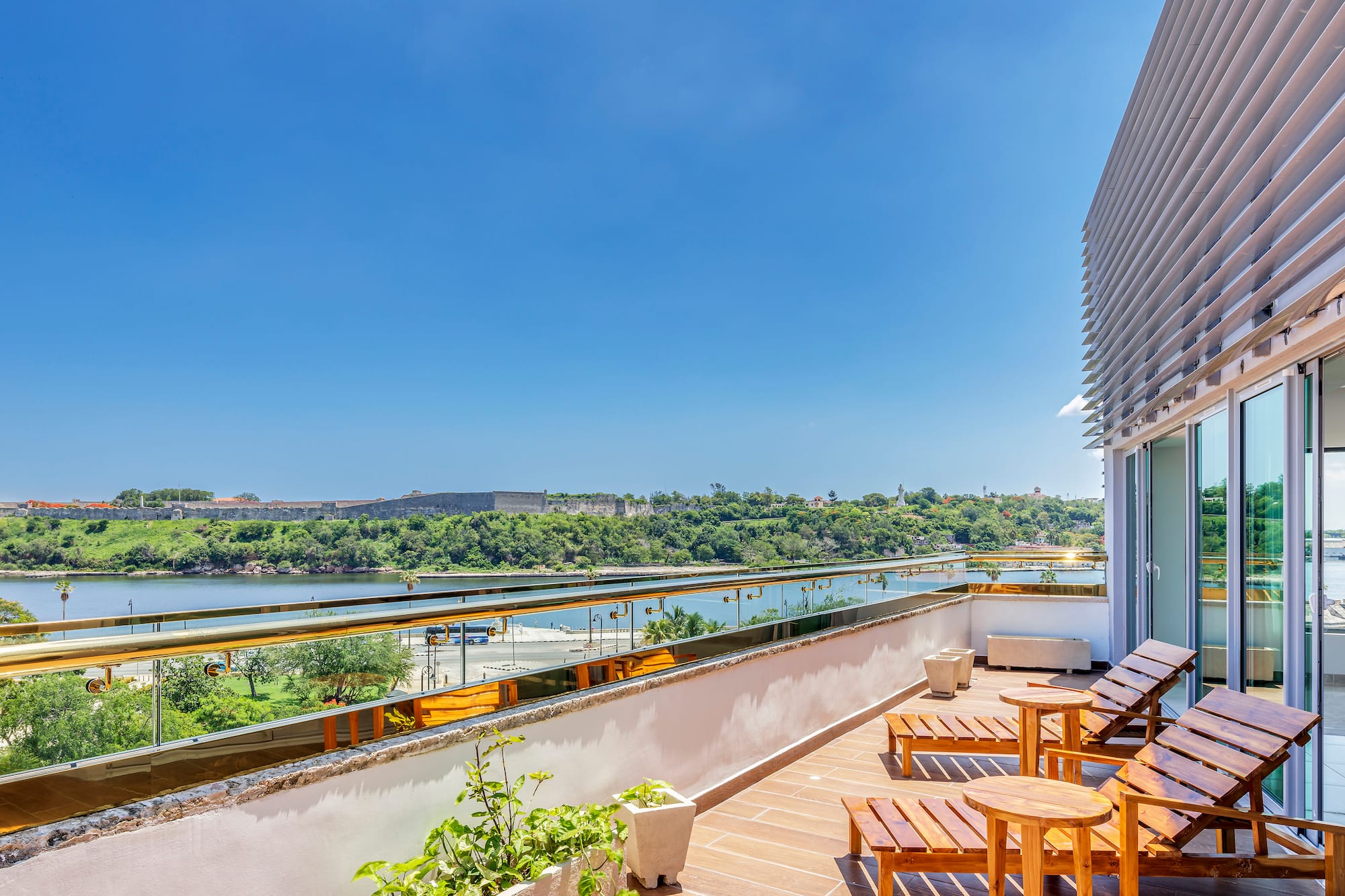 a deck with chairs and a view of a river