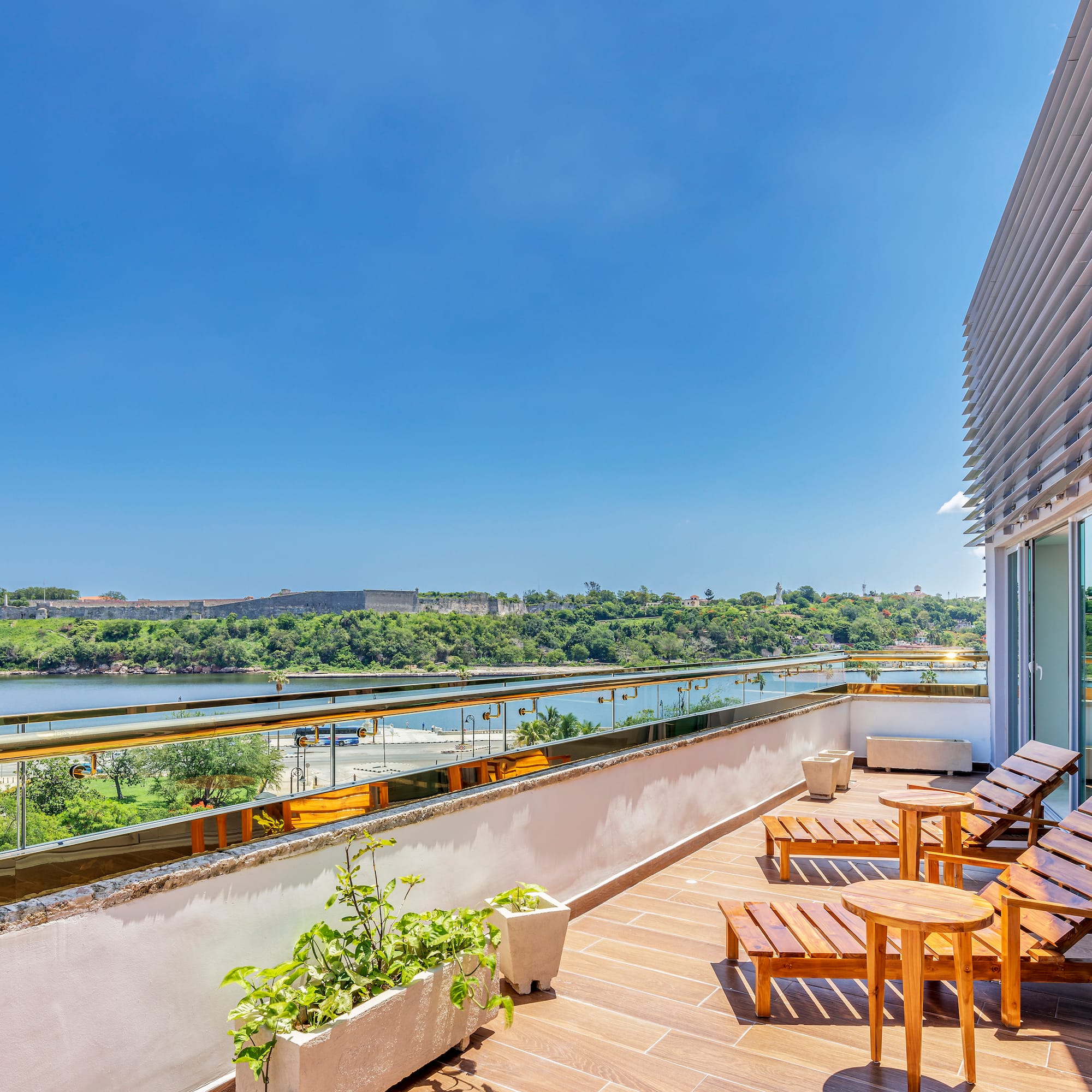 a deck with chairs and a view of a river