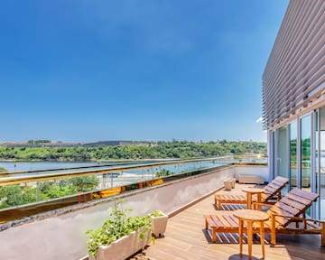 a deck with chairs and a view of a river