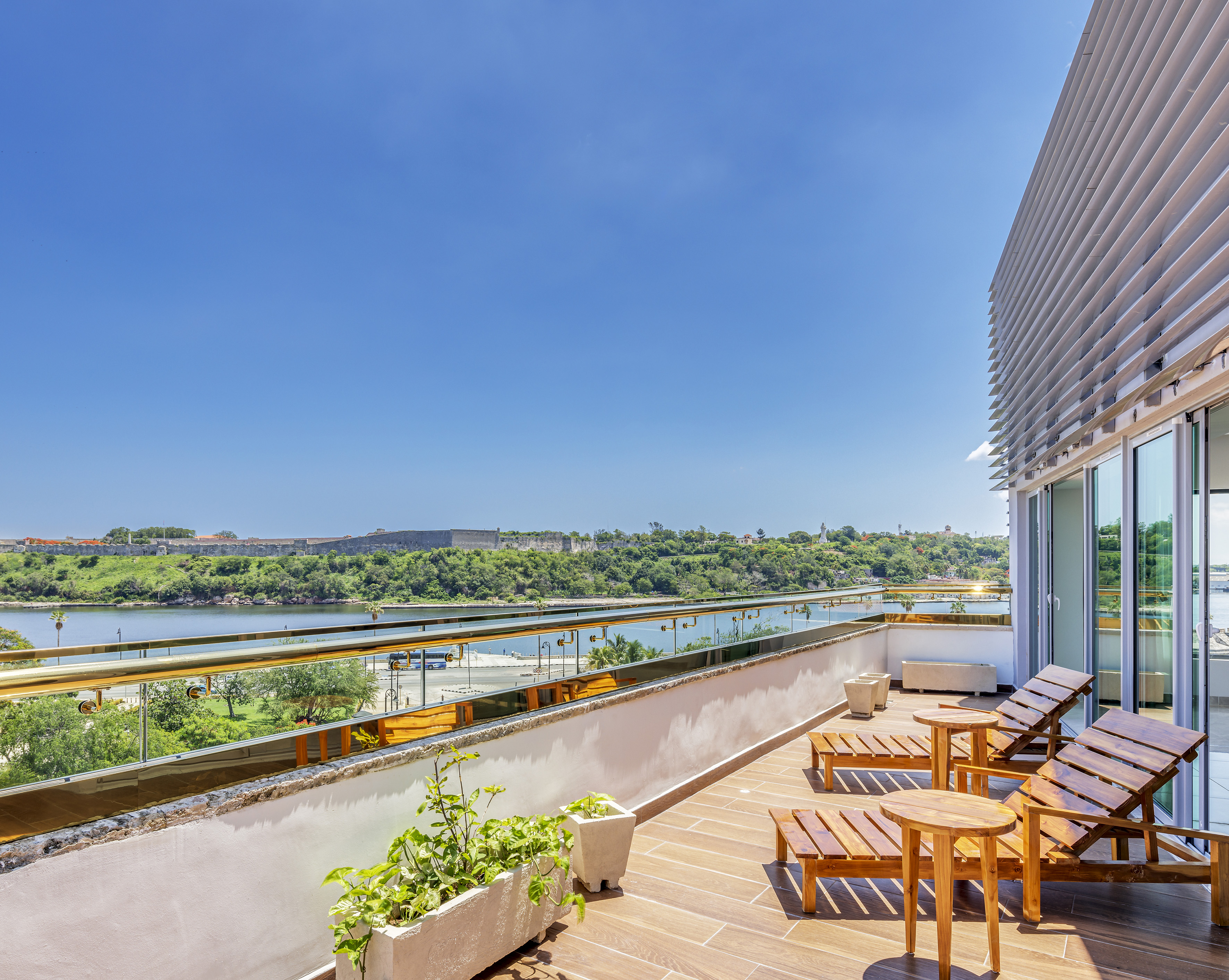 a deck with chairs and a view of a river