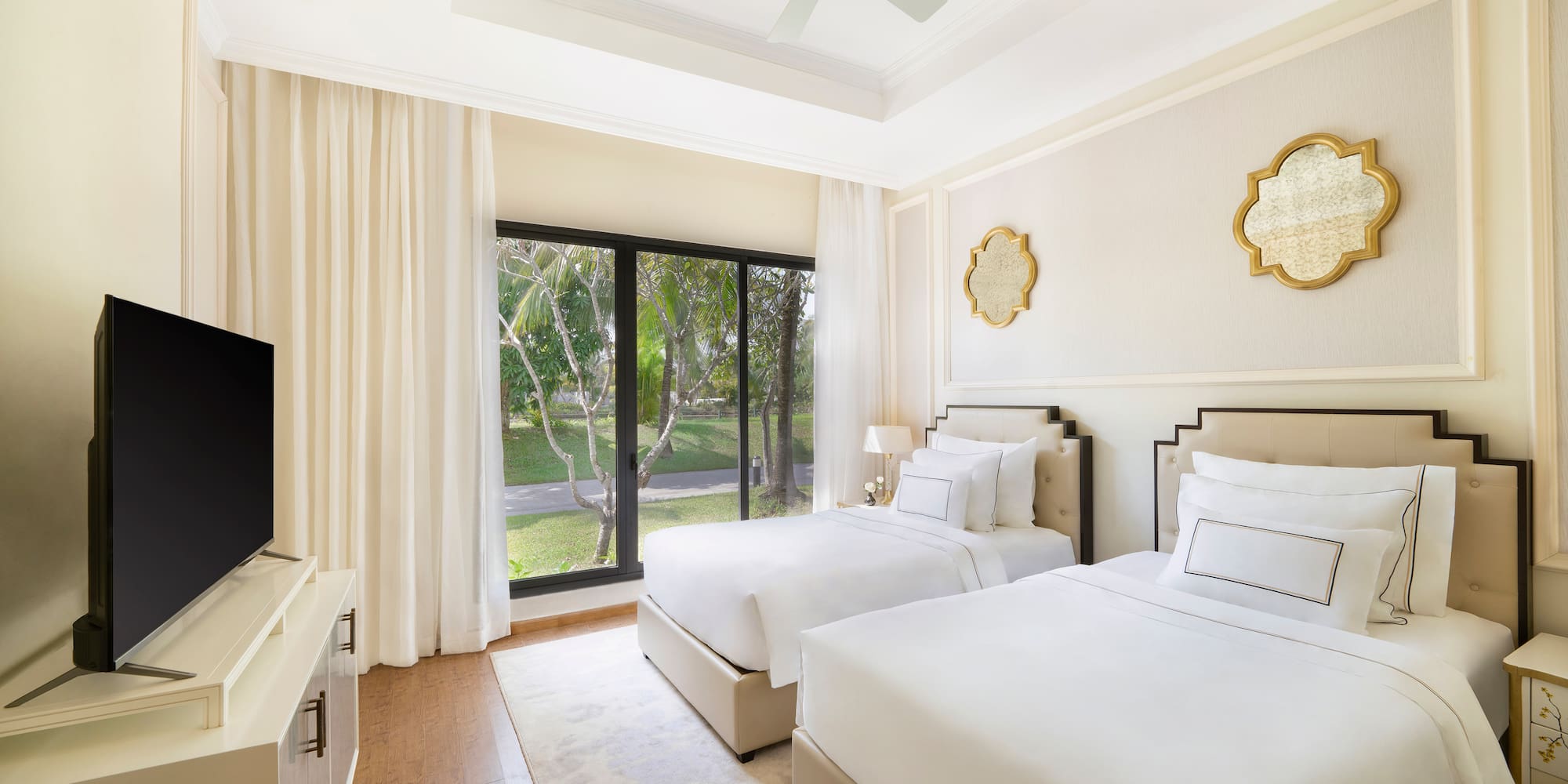 a room with two beds and a television