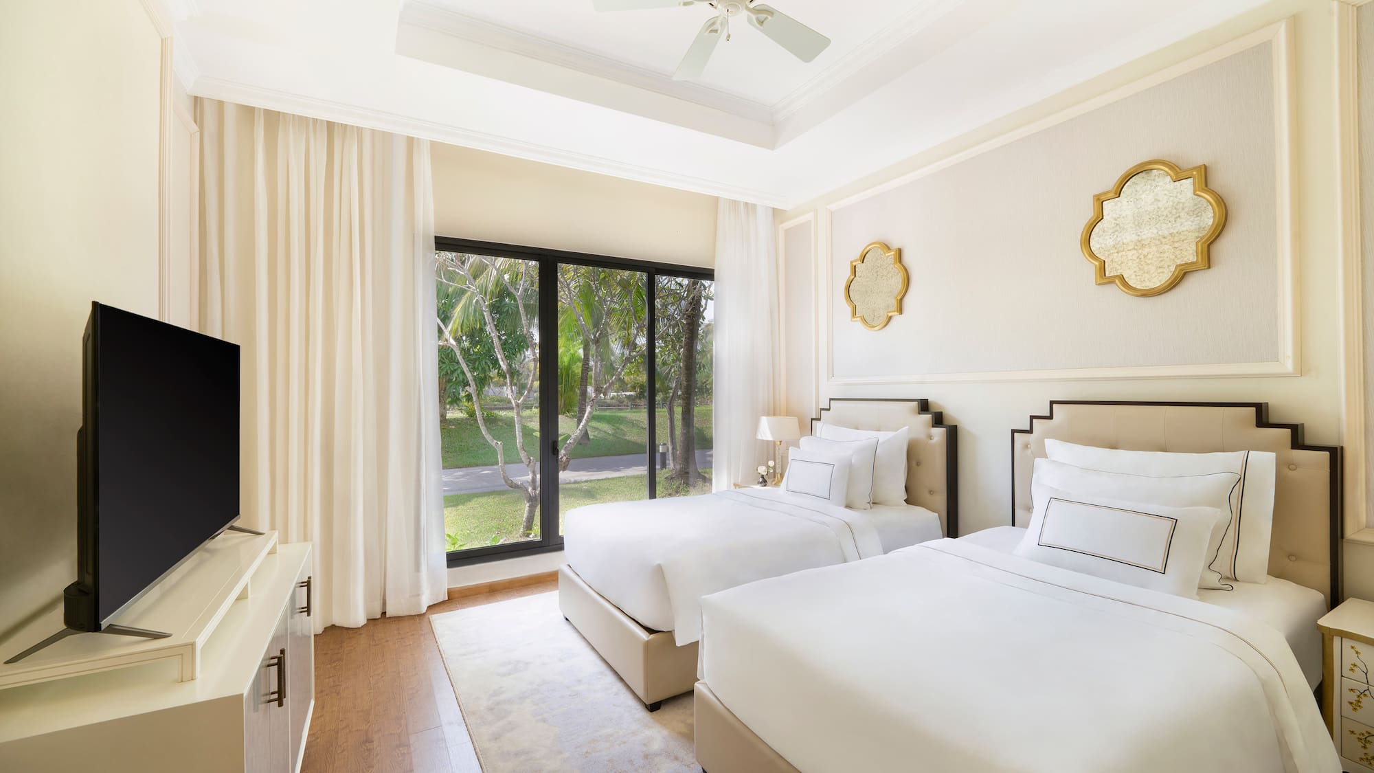 a room with two beds and a television